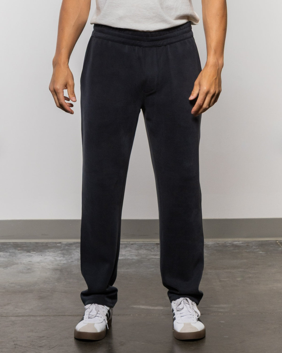 Black jogger-style pants with elastic waistband and cuffed ankles