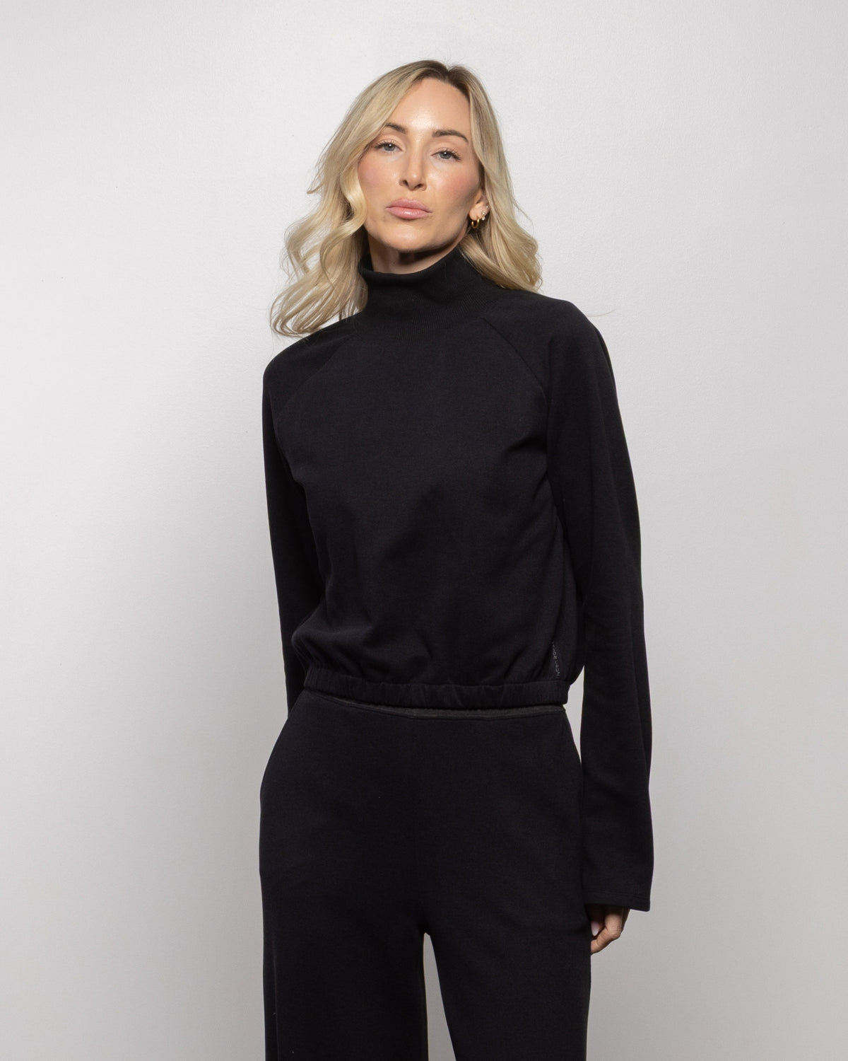 Jet black mock-neck long-sleeve sweatshirt with gathered waistband and cuffs