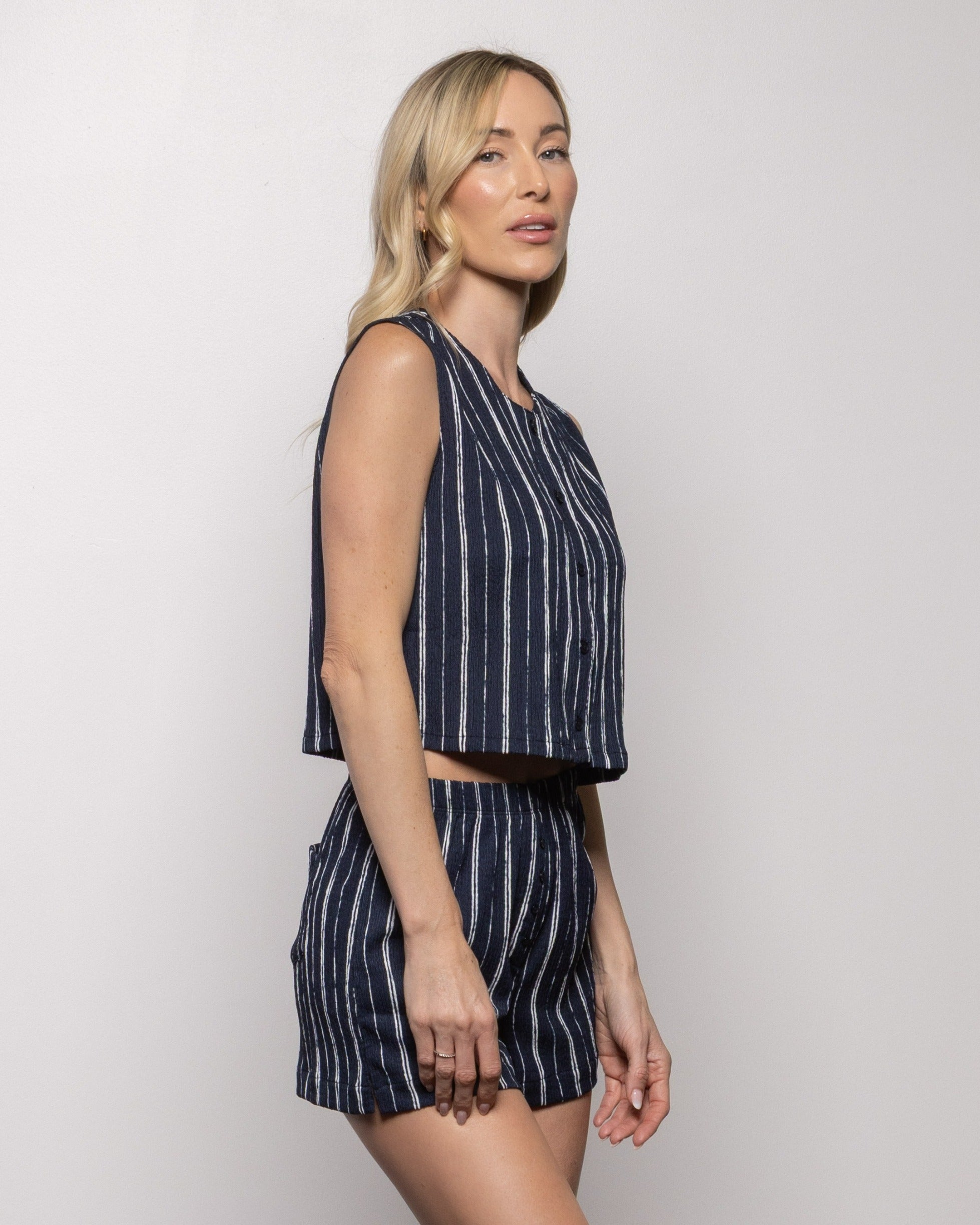Indigo striped sleeveless crop top with round neckline and side view