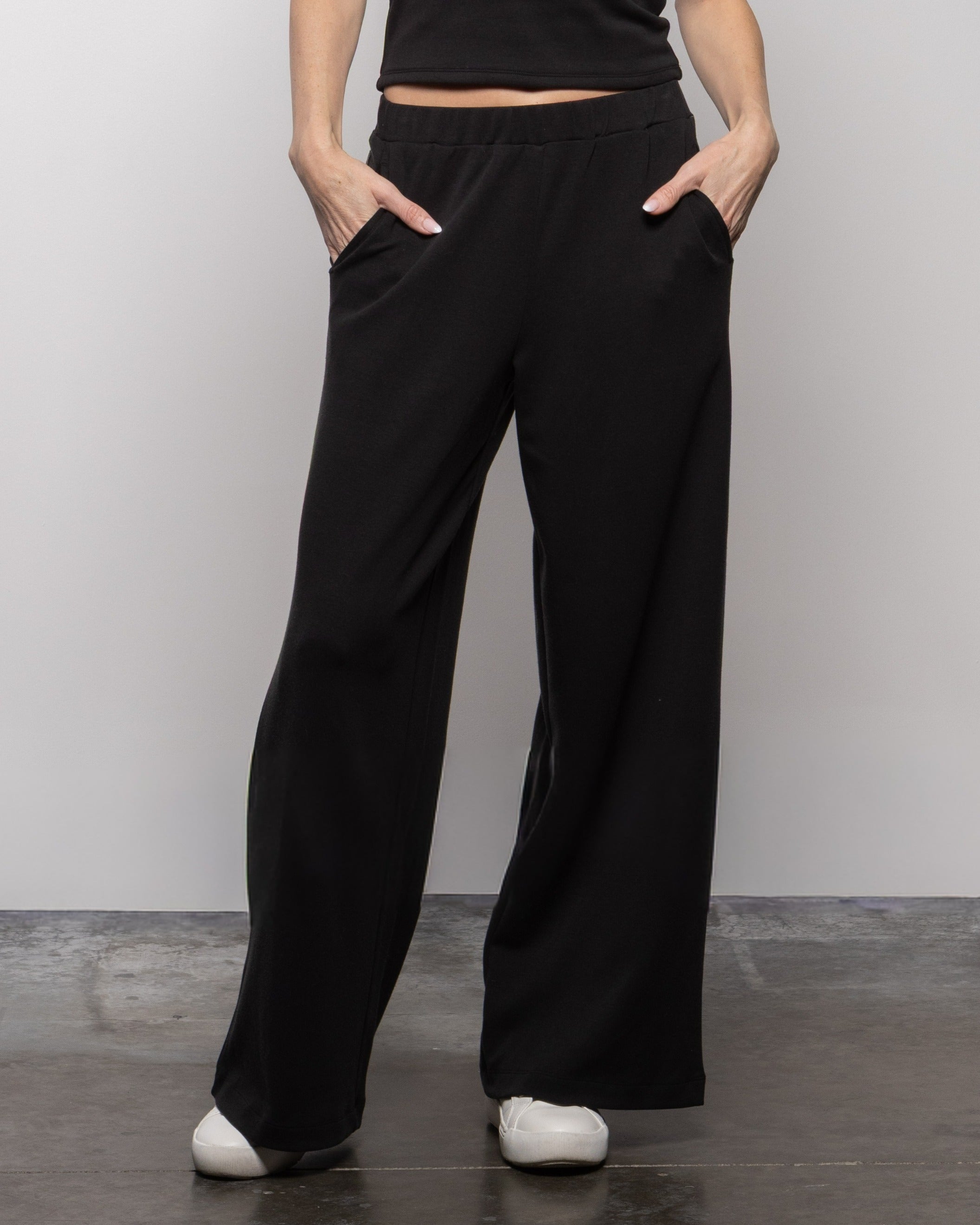Jet black high-rise wide-leg pants with hip pockets and straight wide legs