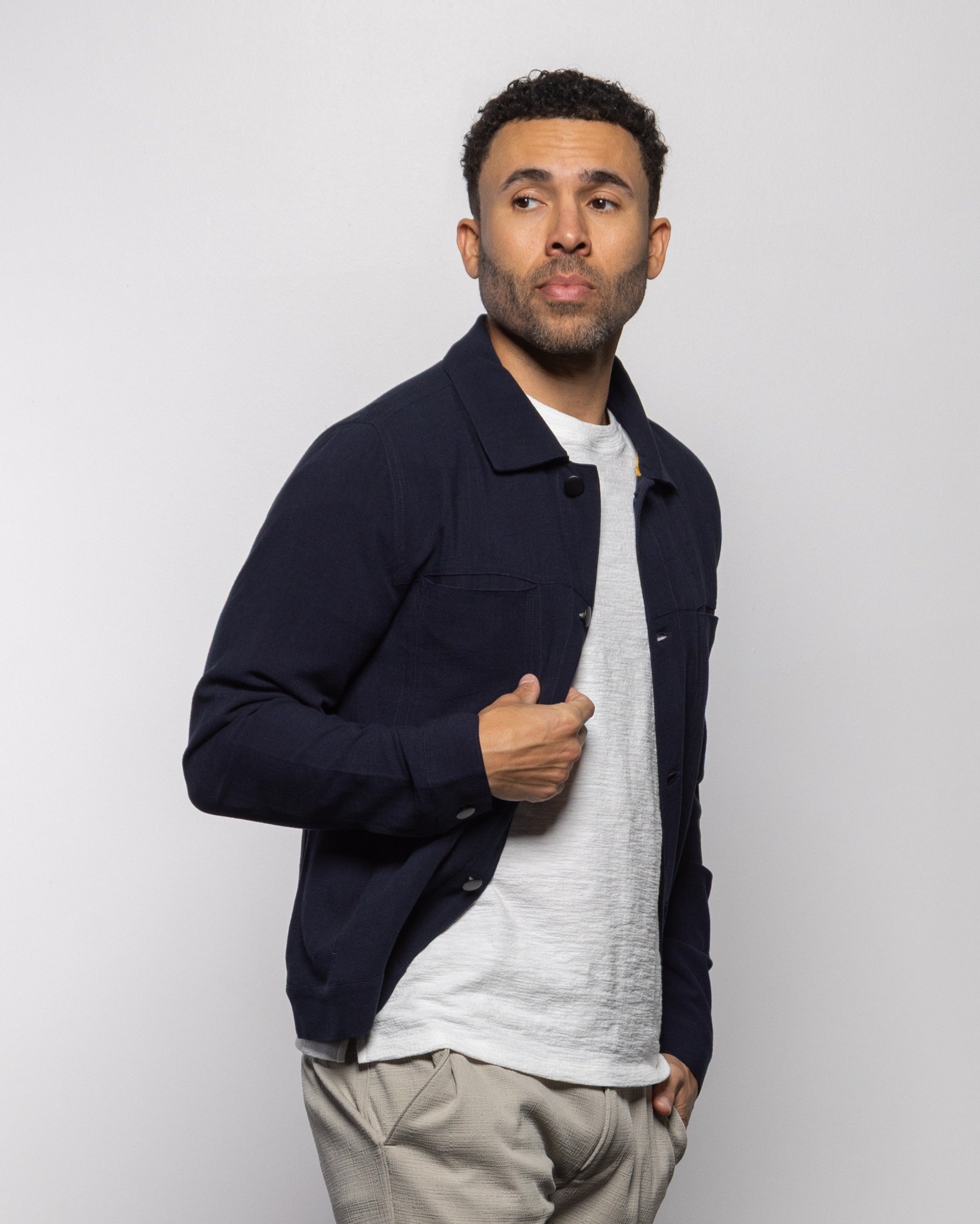 Indigo trucker jacket with button placket, collar, and flap chest pocket