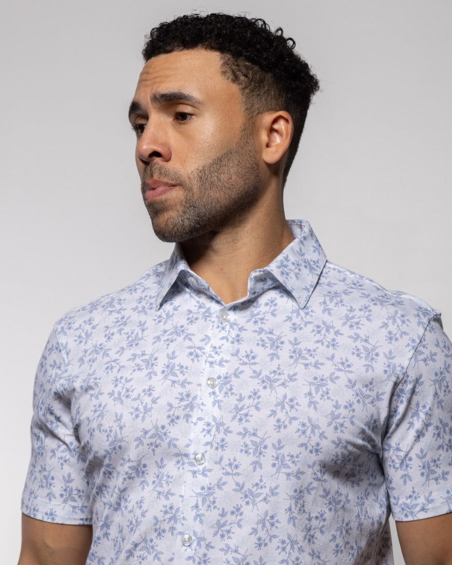 Light blue floral short-sleeve polo with point collar and button placket