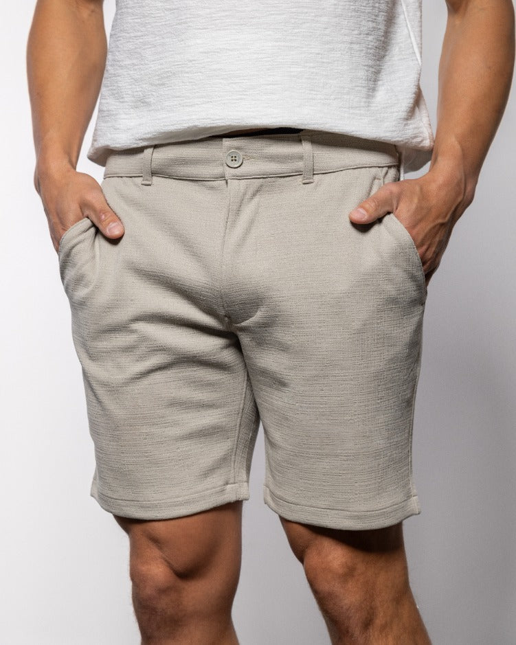 Light gray men’s chino shorts with button closure, belt loops, and side pockets