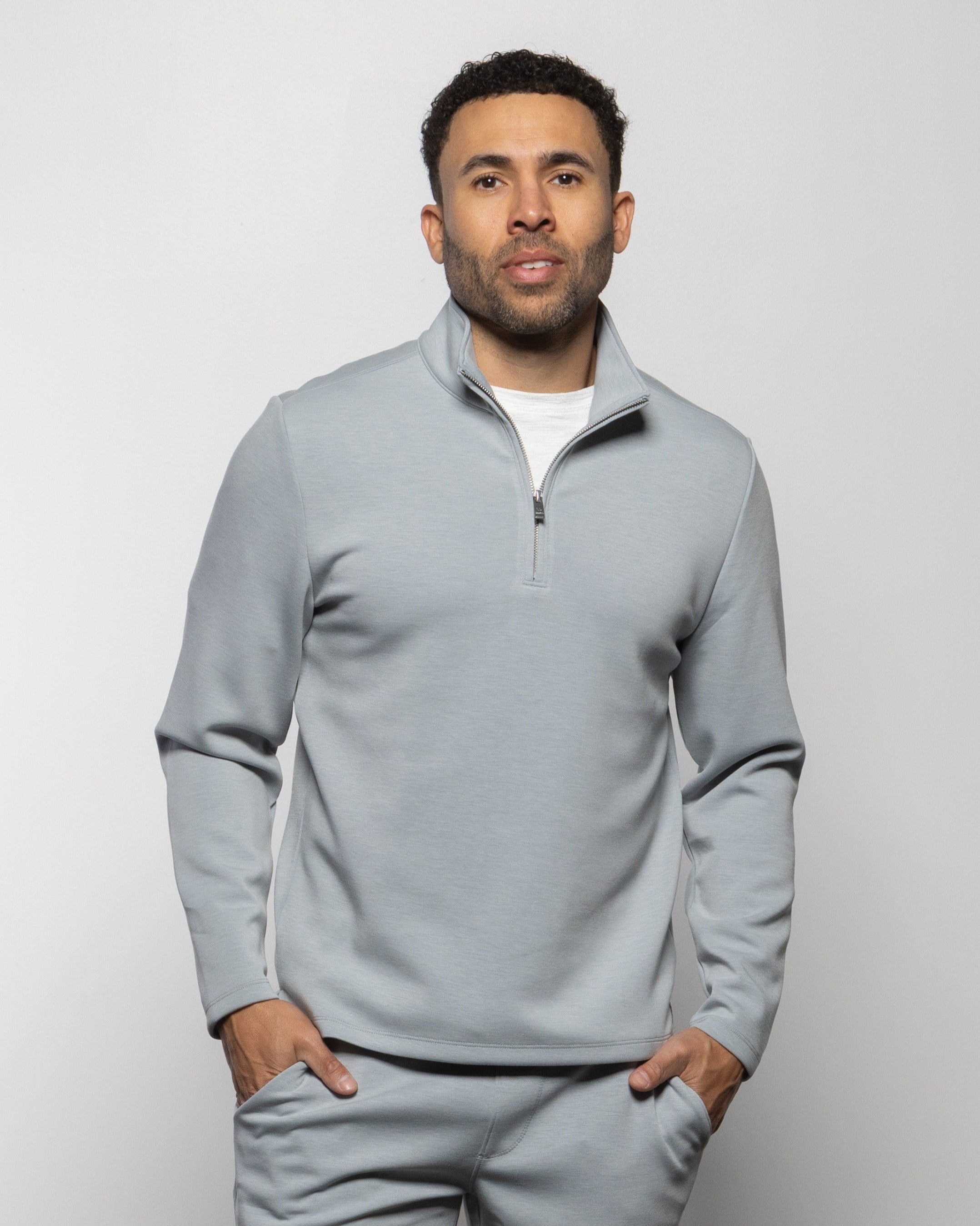 Light gray quarter-zip sweatshirt with half-zip placket and long sleeves