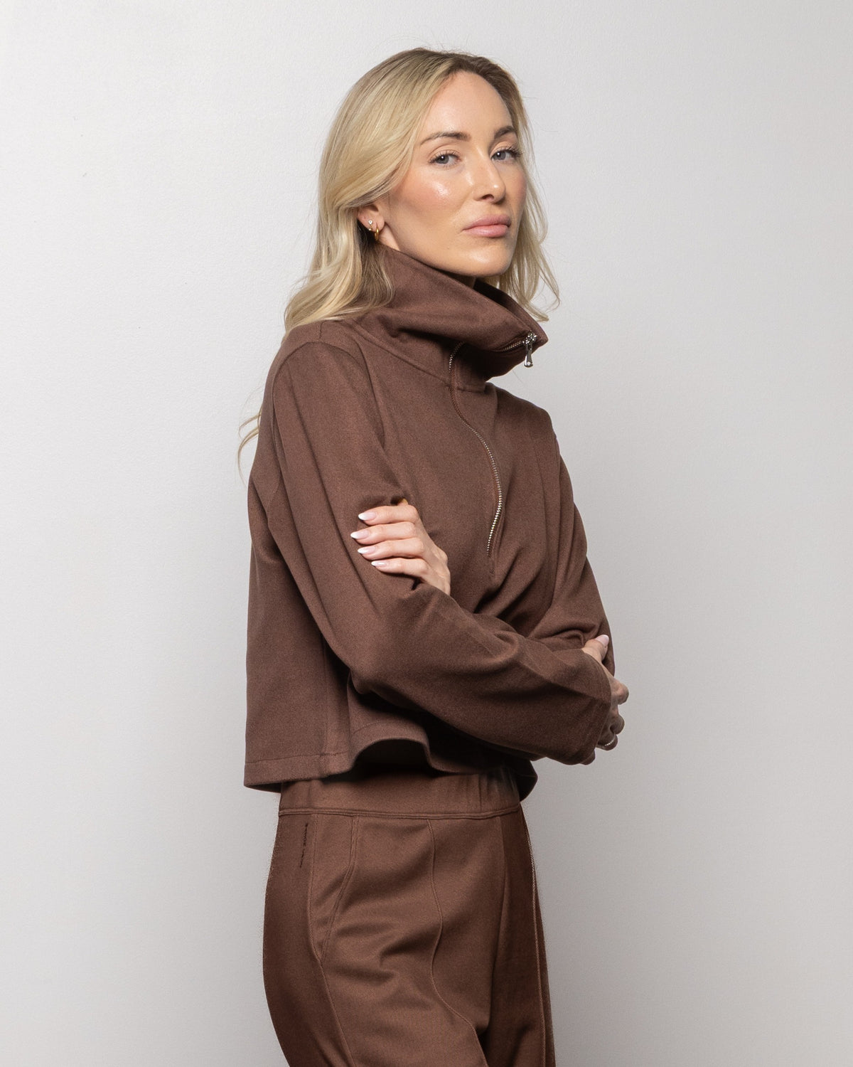 Brown half-zip pullover side view with mock collar and zip front, long sleeves