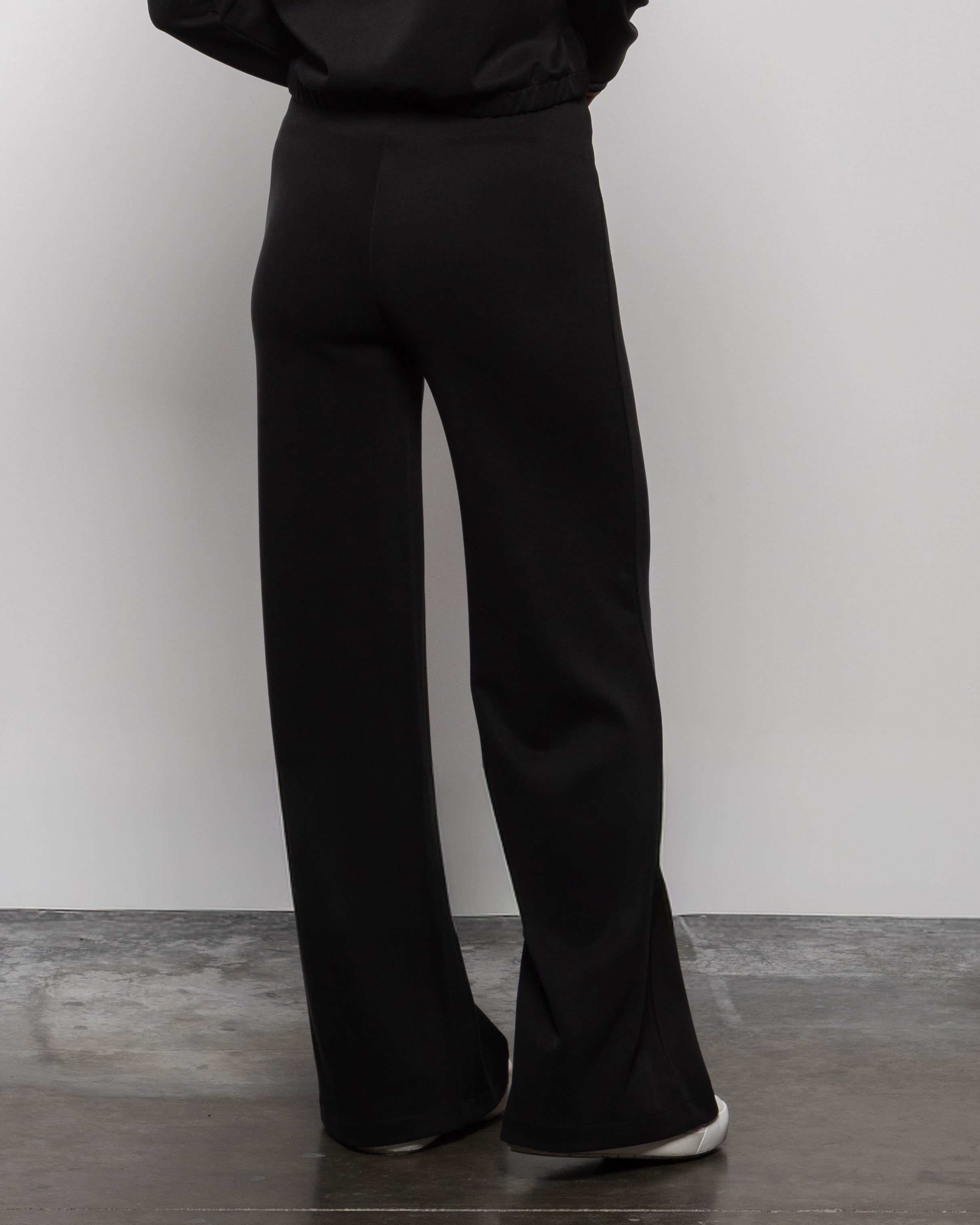 Matte black wide-leg trouser pants with long straight flared legs