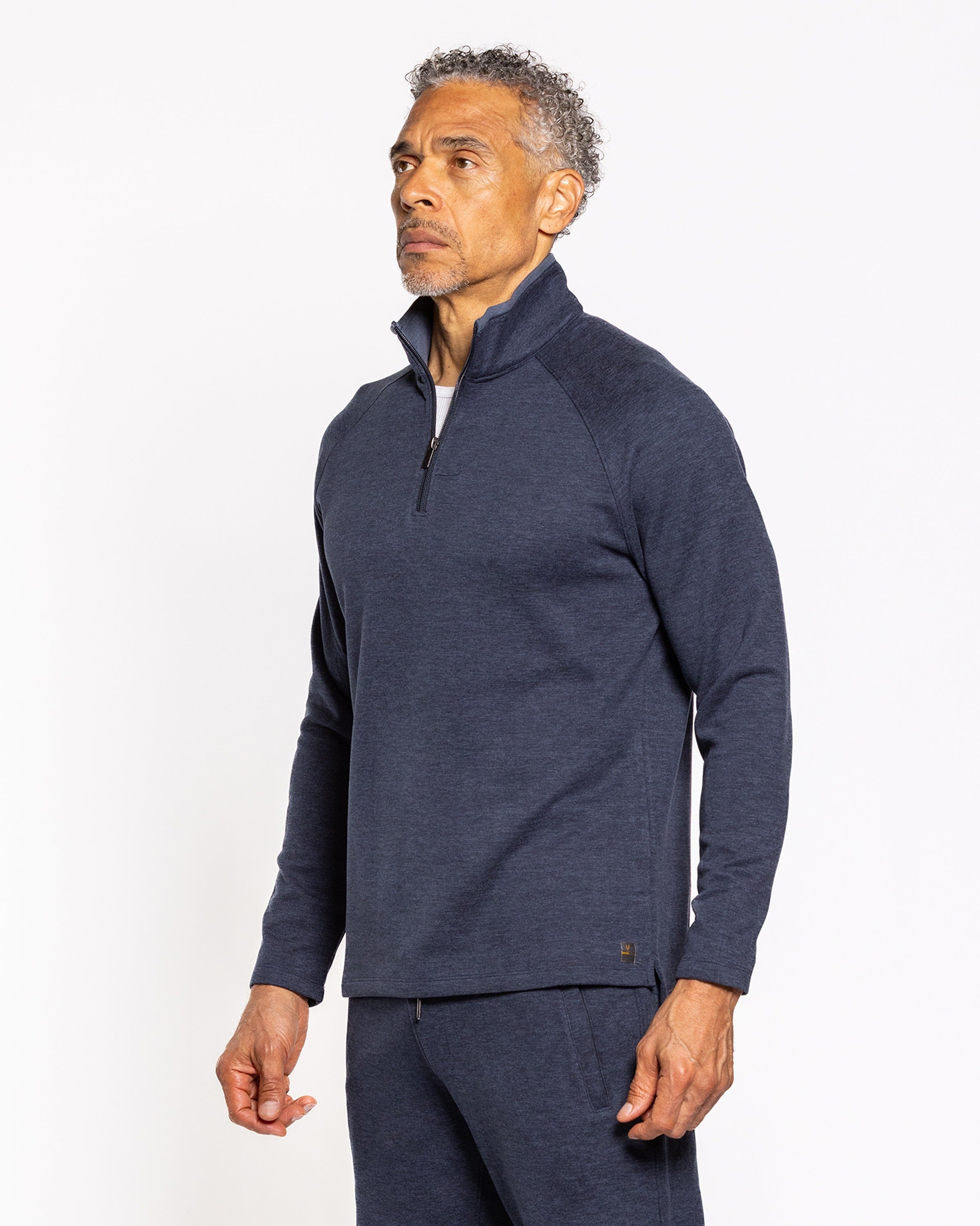 Men's dark indigo quarter-zip pullover side view with long sleeves and zipper placket.