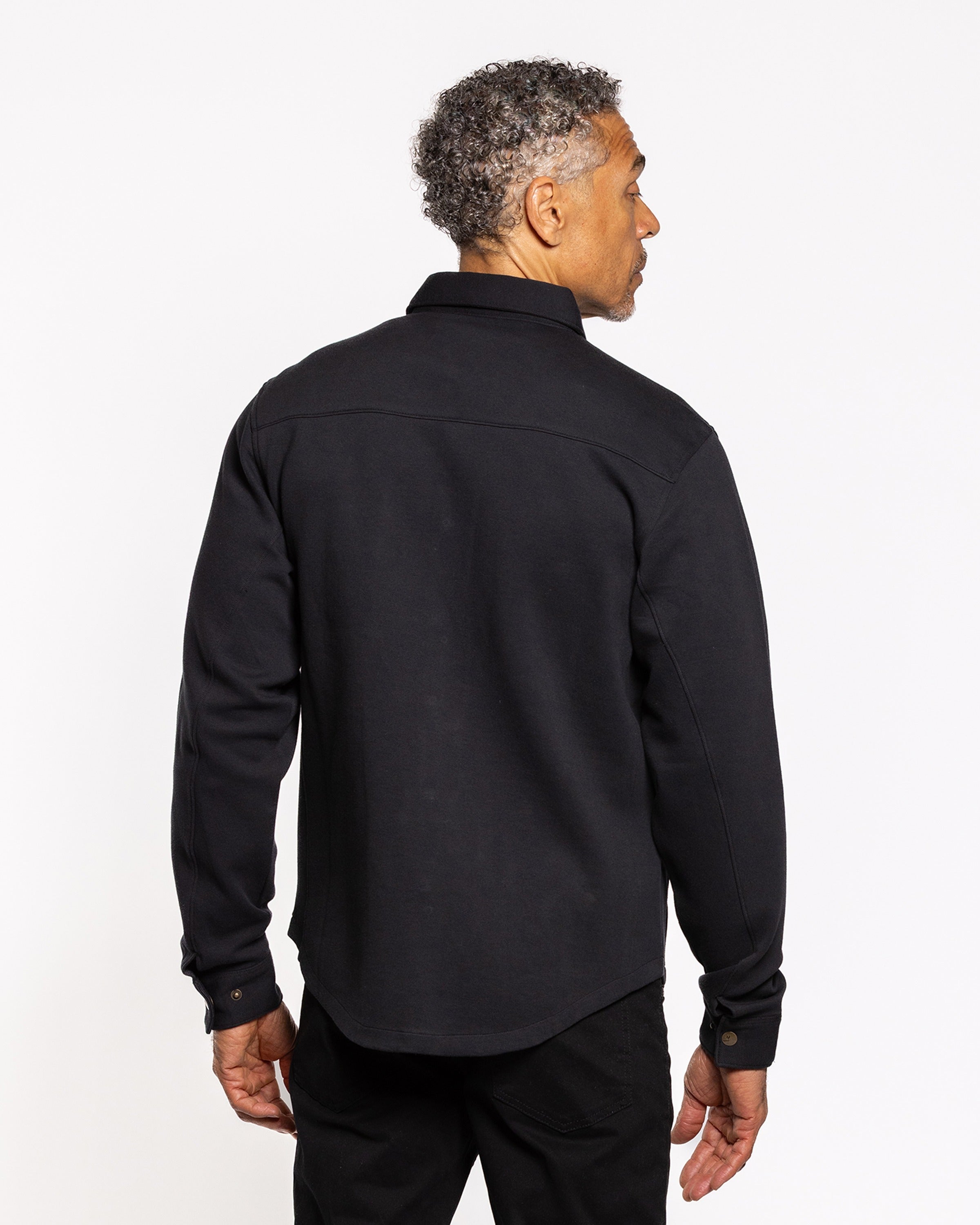 Black shirt jacket back view with full-length hem and long sleeves