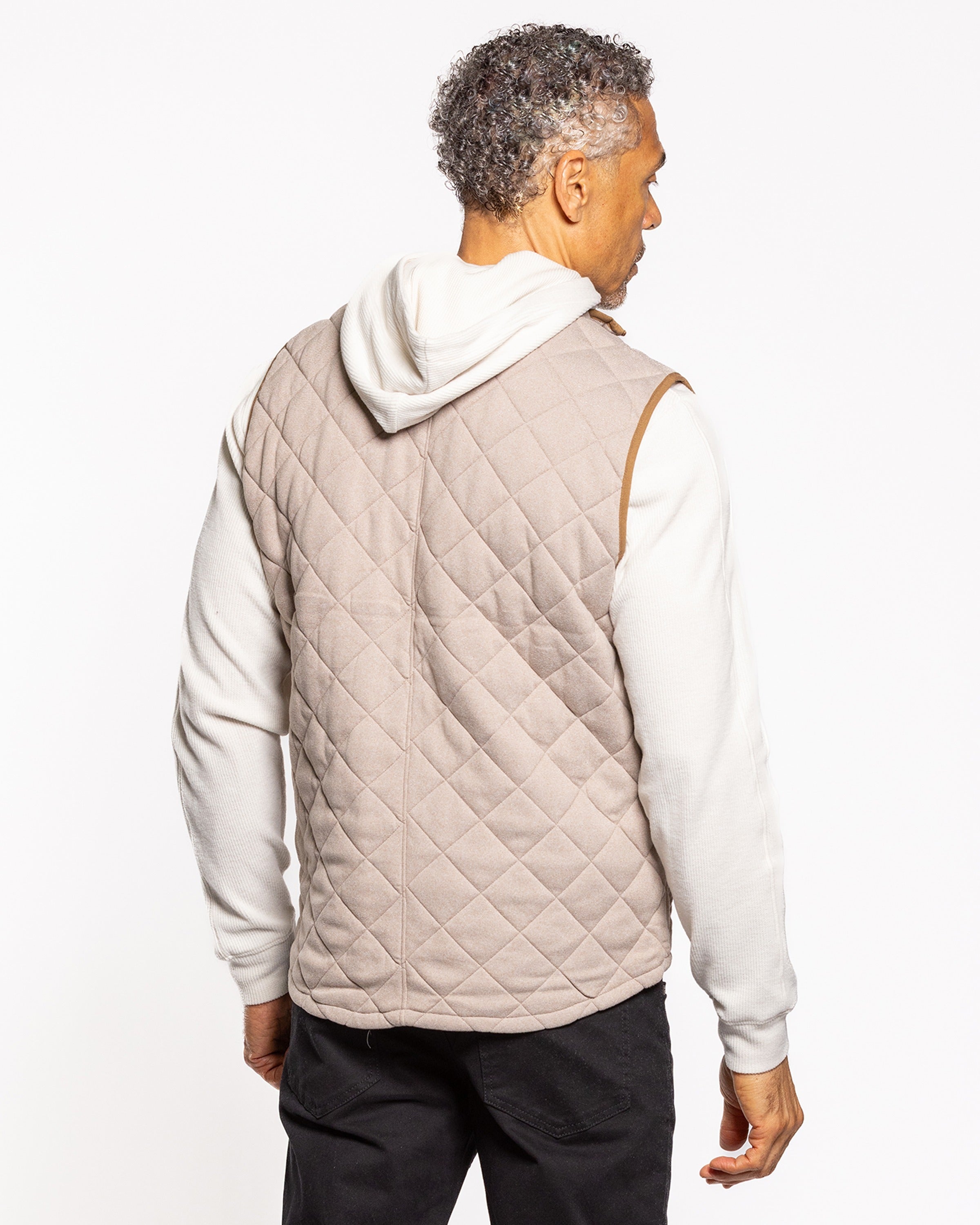 Light gray quilted sleeveless vest with diamond pattern, worn over hoodie