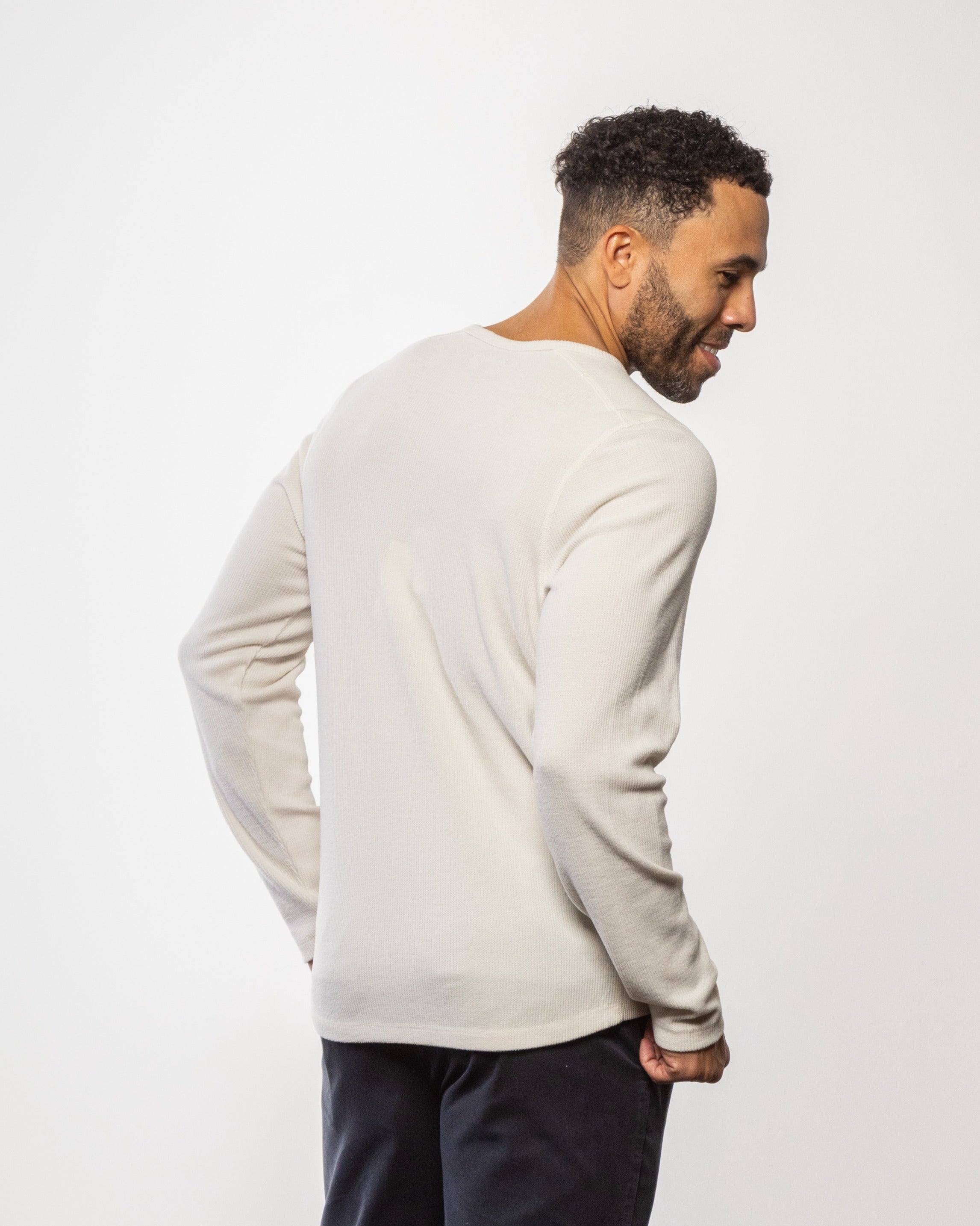 Light off-white crewneck long-sleeve knit shirt, back view