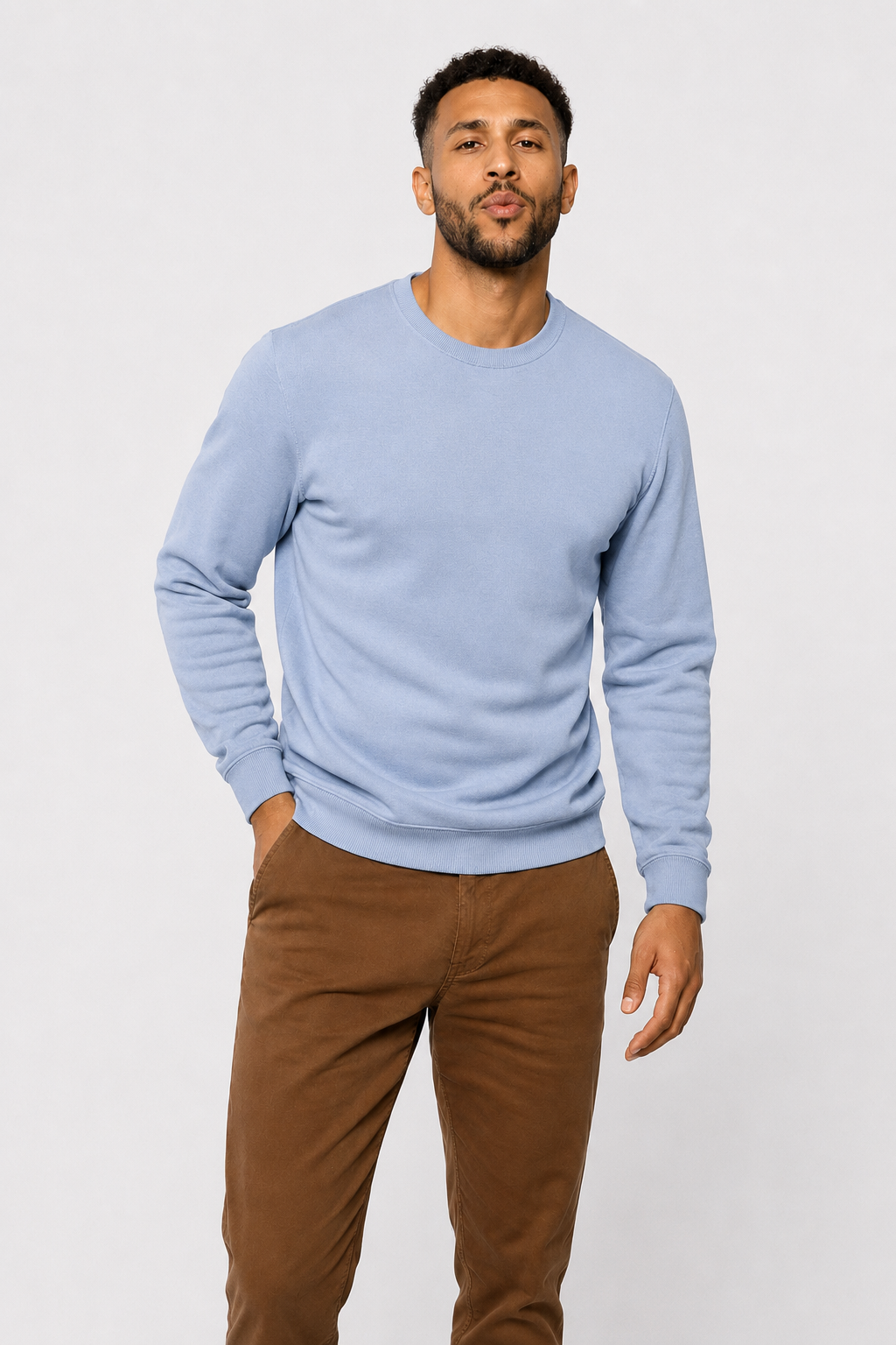 Light blue crewneck sweater with long sleeves, ribbed cuffs and hem; hand in pocket