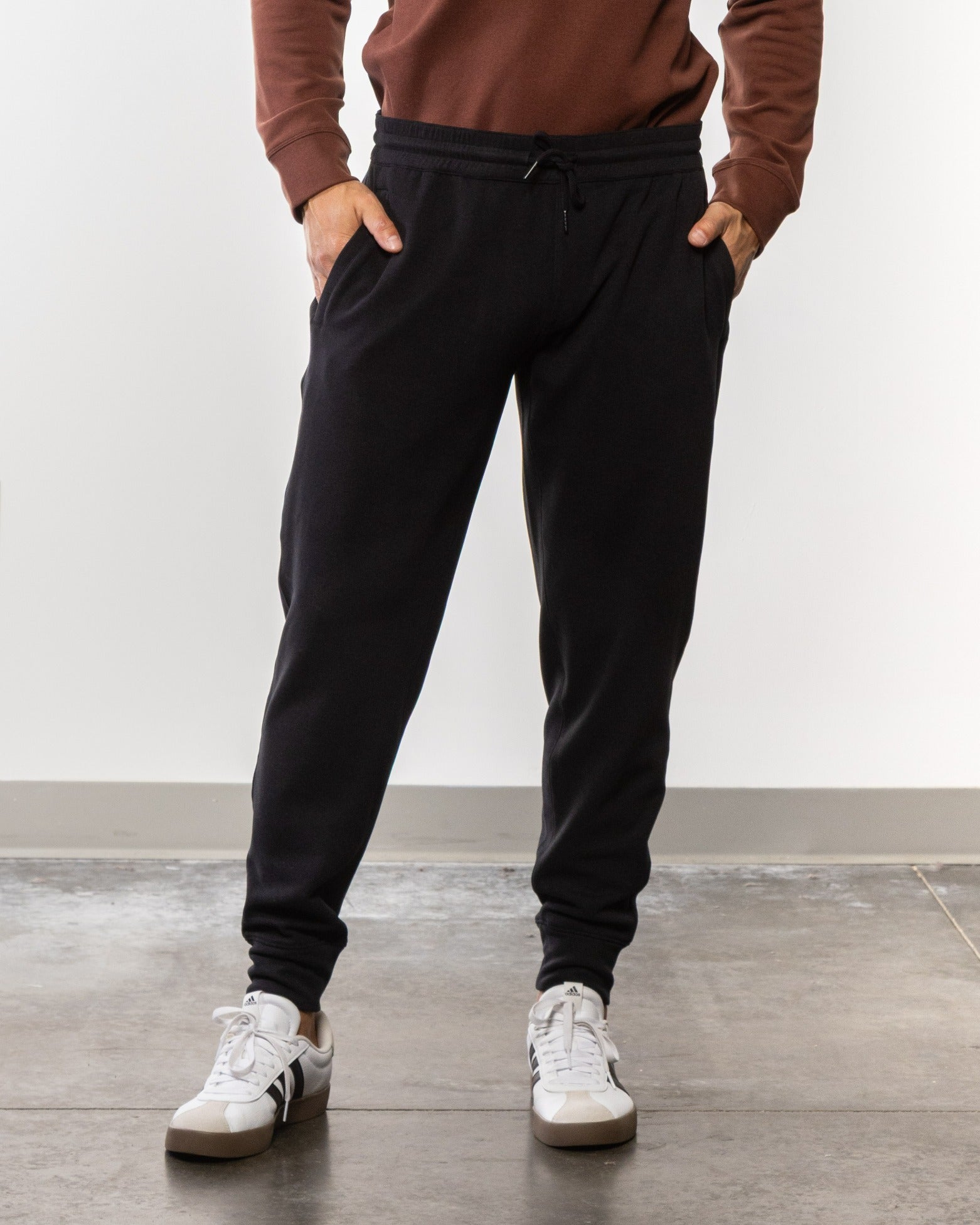 Black jogger pants with elastic waistband, drawstring, and tapered cuffs