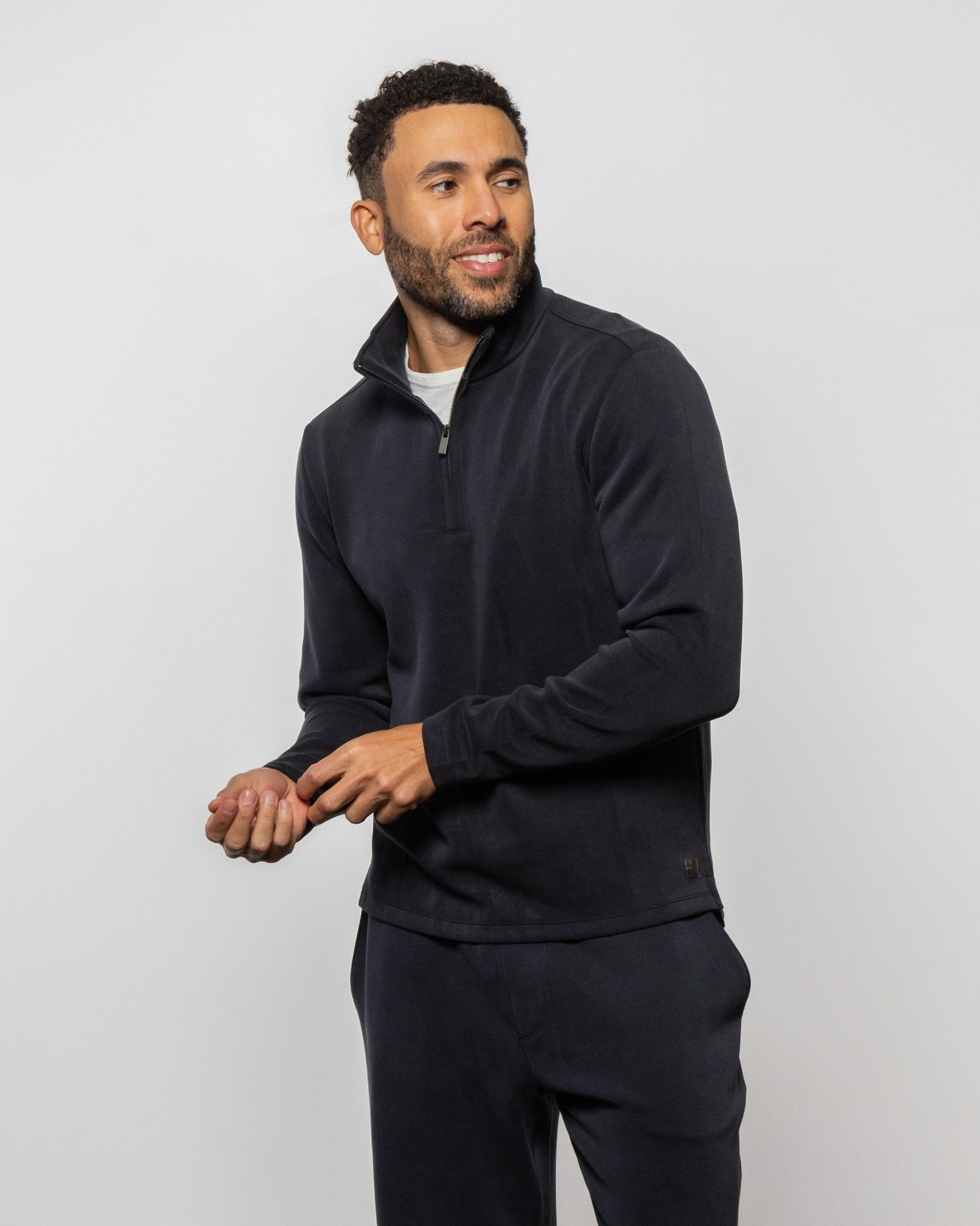 Black quarter-zip pullover fleece top with long sleeves and half-zip collar