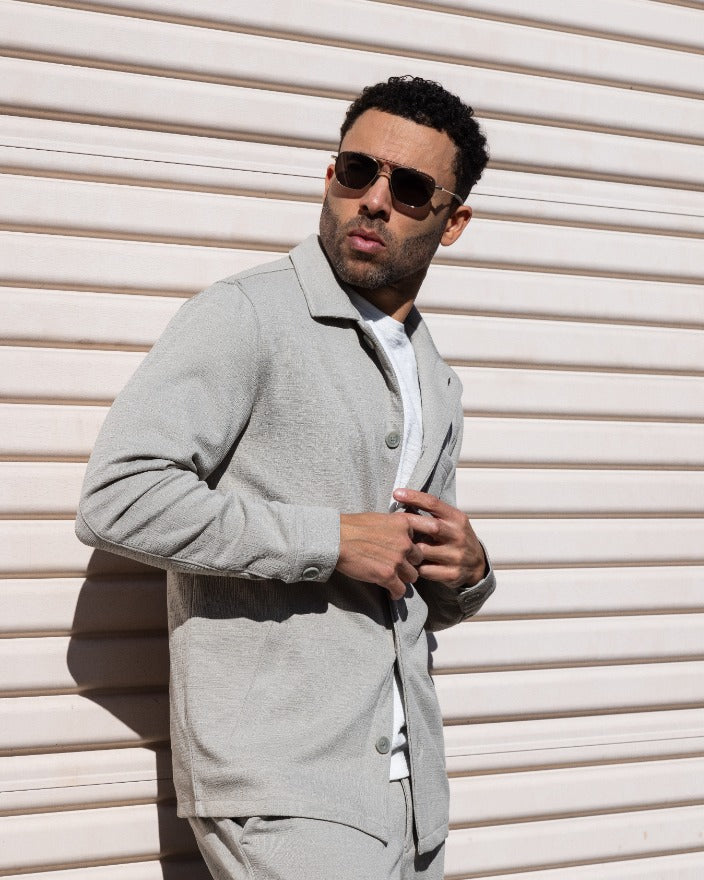 Light gray button-front jacket with notched collar and flap pockets