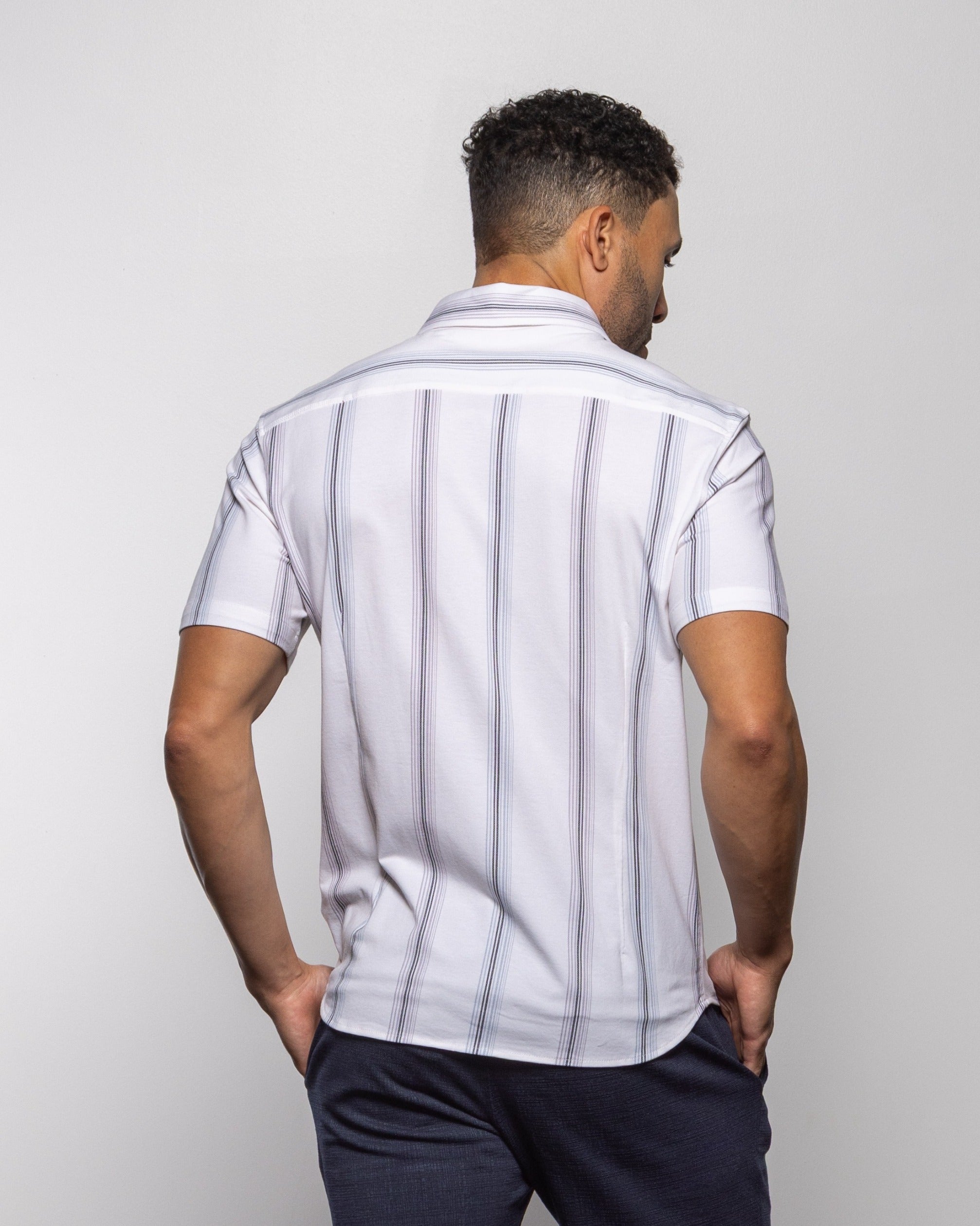 Men's white button-up shirt, back view, with vertical light-blue stripes and short sleeves