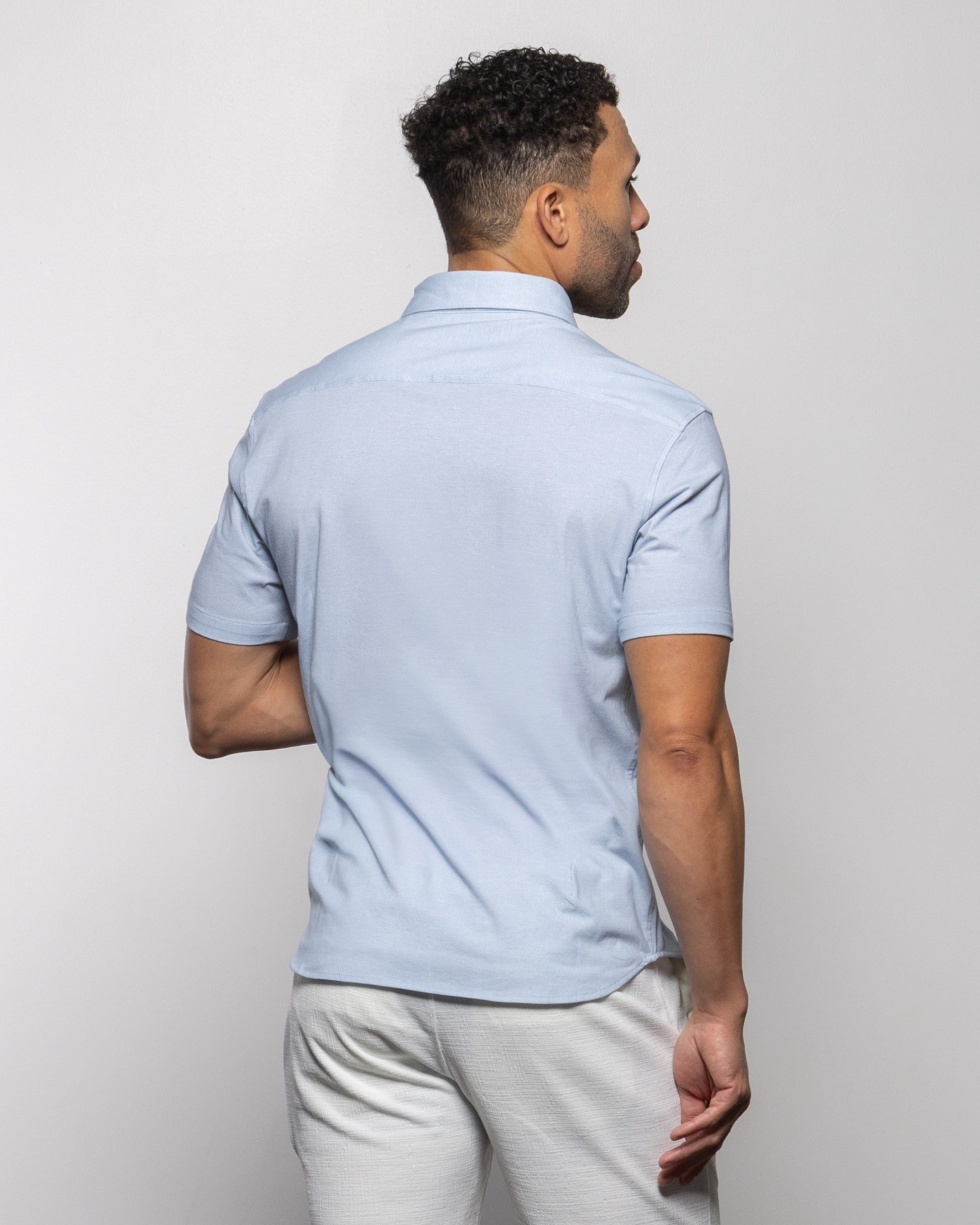 Light blue linen polo shirt back view, short sleeves and collar