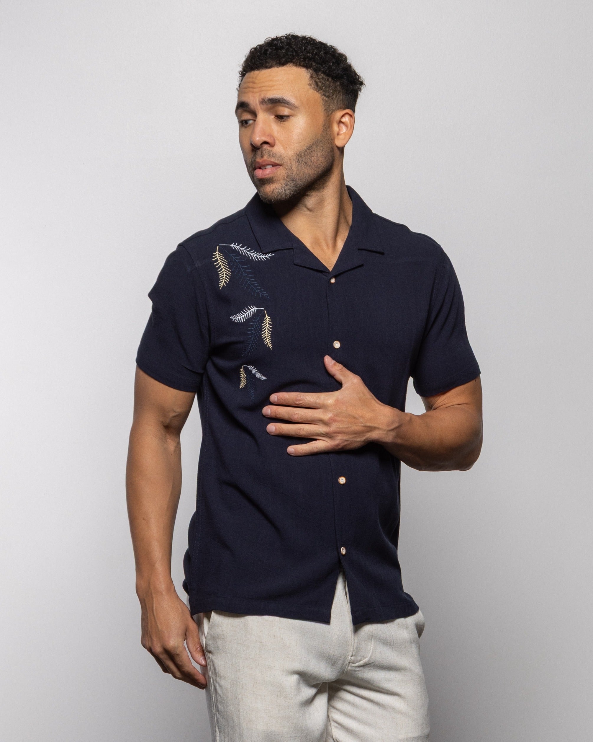 Indigo camp shirt with button front and leaf embroidery, short sleeves, pointed collar