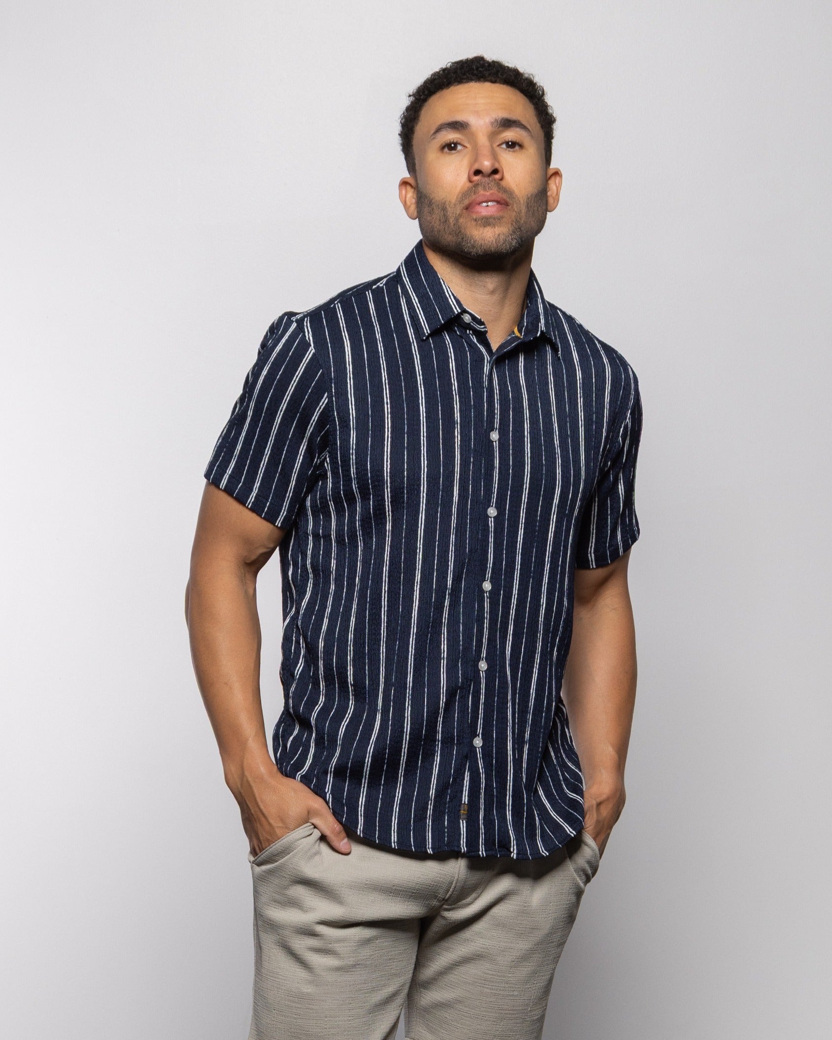 Men's short-sleeve indigo striped button-up shirt, full front view with buttons