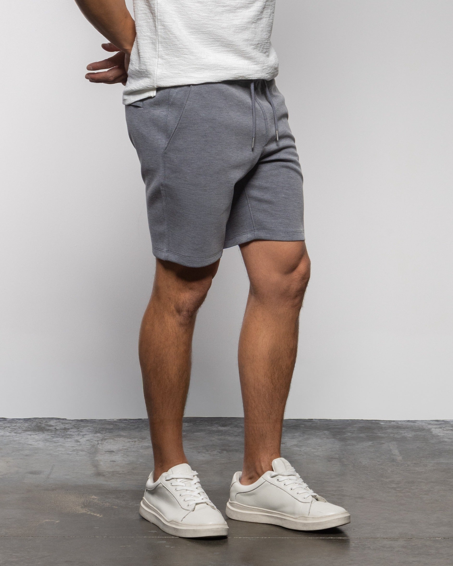 Men's concrete gray drawstring shorts, back view with side pockets