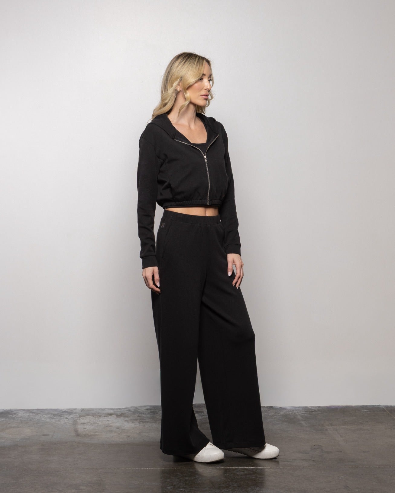 High-rise jet black wide-leg pants with elastic waistband and side pockets
