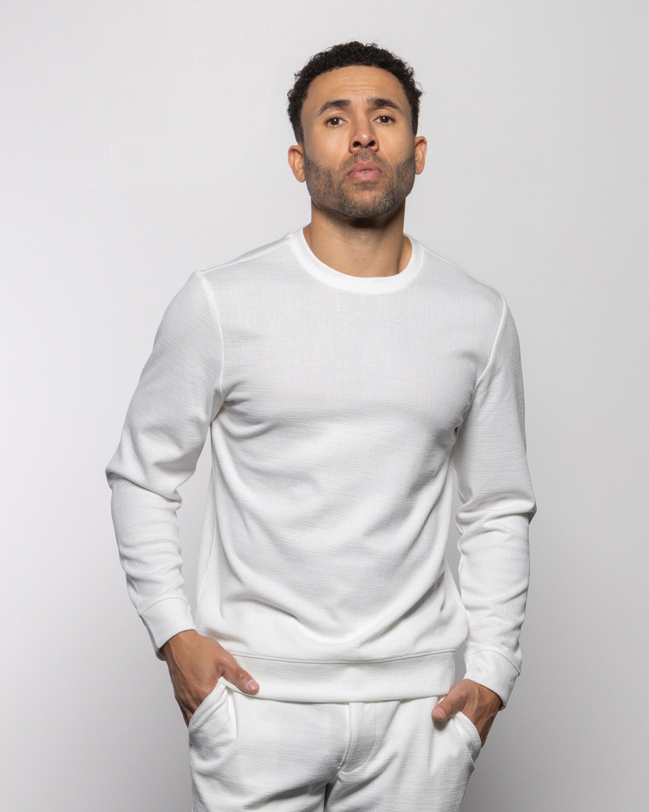 Men's white crewneck sweatshirt with ribbed collar, cuffs, and hem