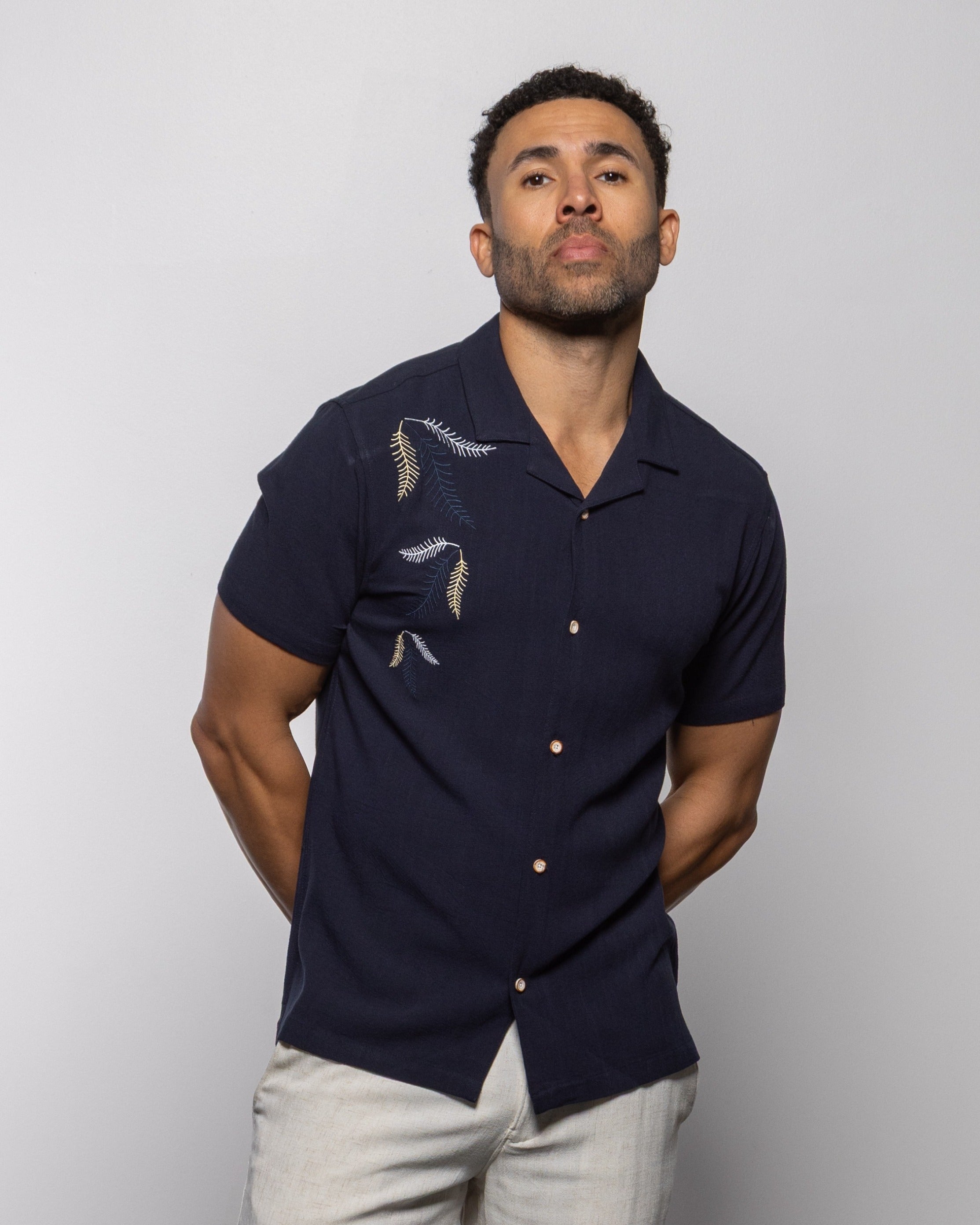 Indigo camp shirt front view with leaf embroidery, short sleeves, button placket