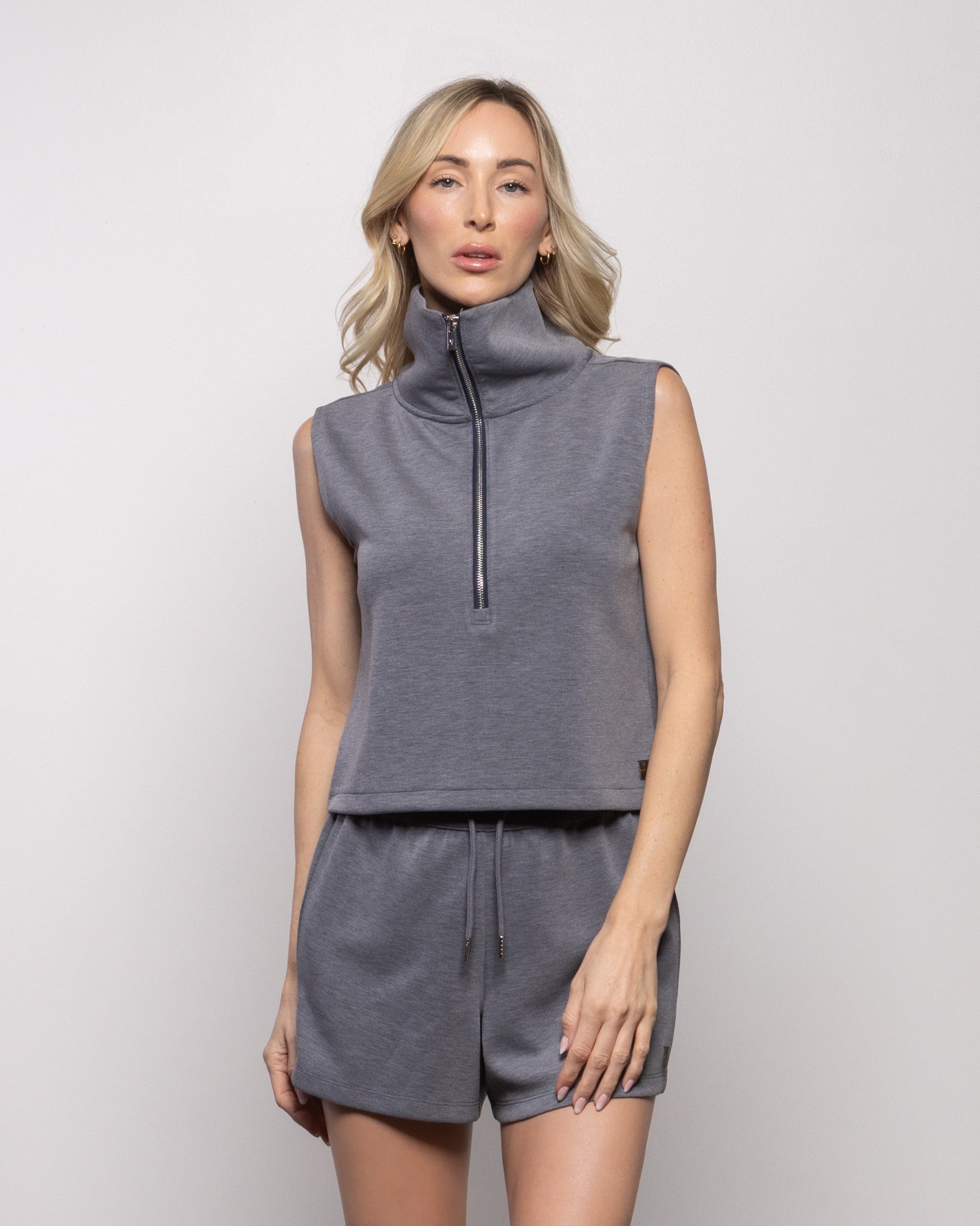 Dark gray sleeveless half-zip tank top with matching drawstring shorts