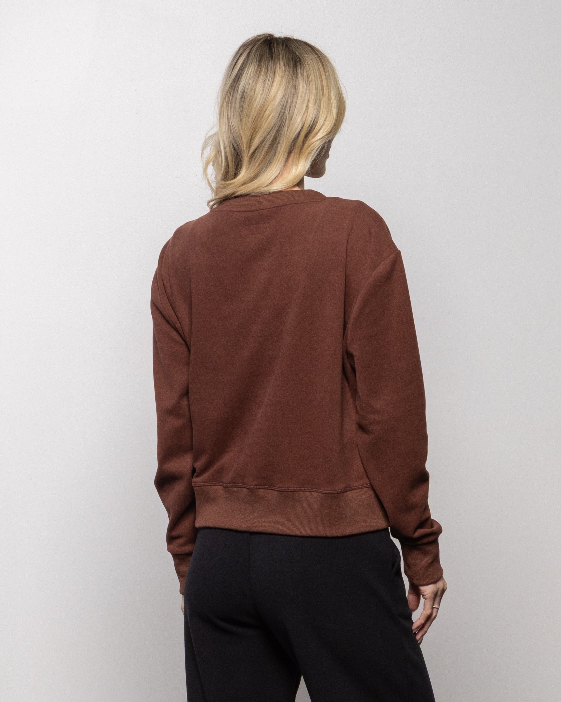 Brick red cardigan sweater, back view with buttonless back and ribbed hem and cuffs