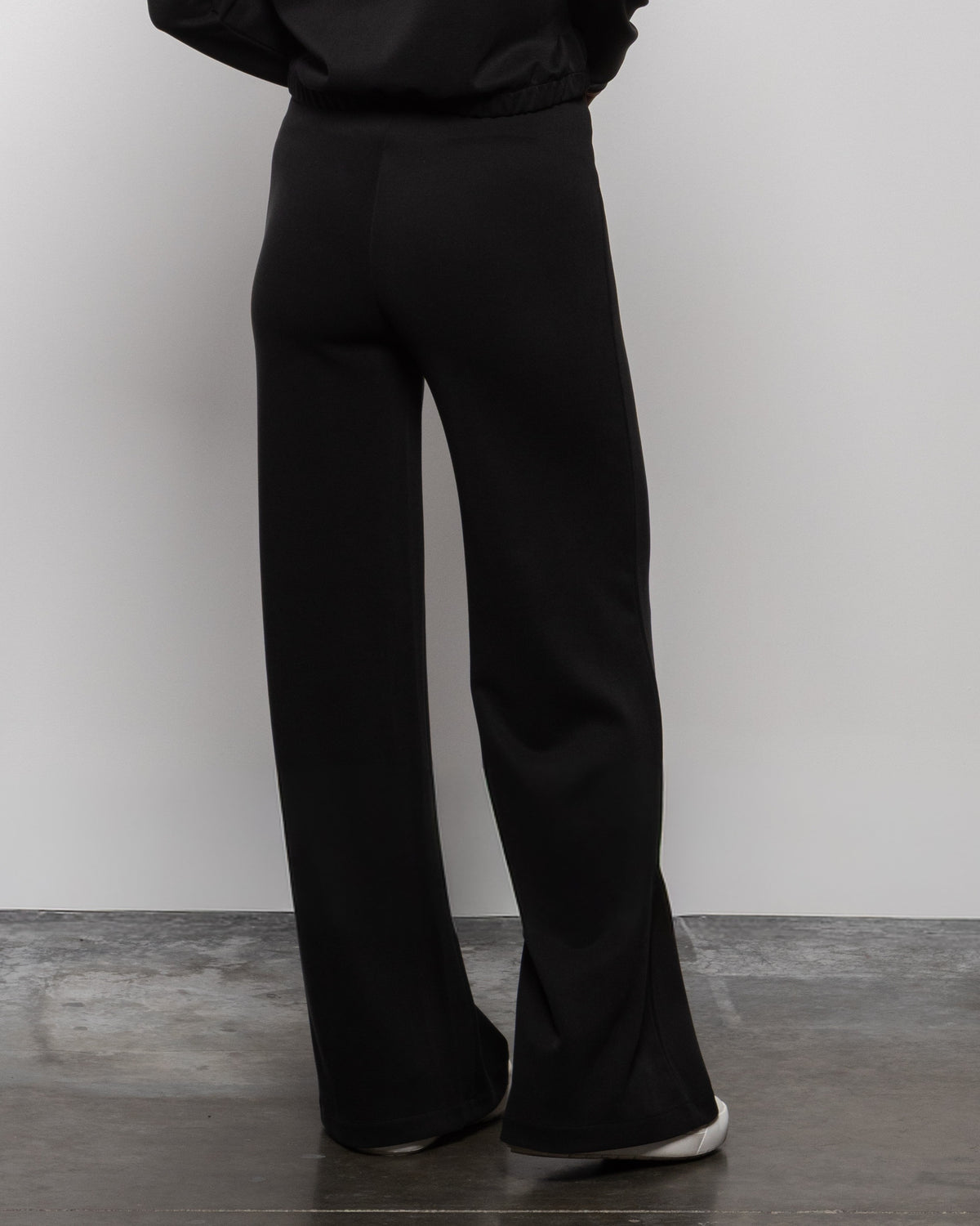 Matte black wide-leg trouser pants with long straight flared legs