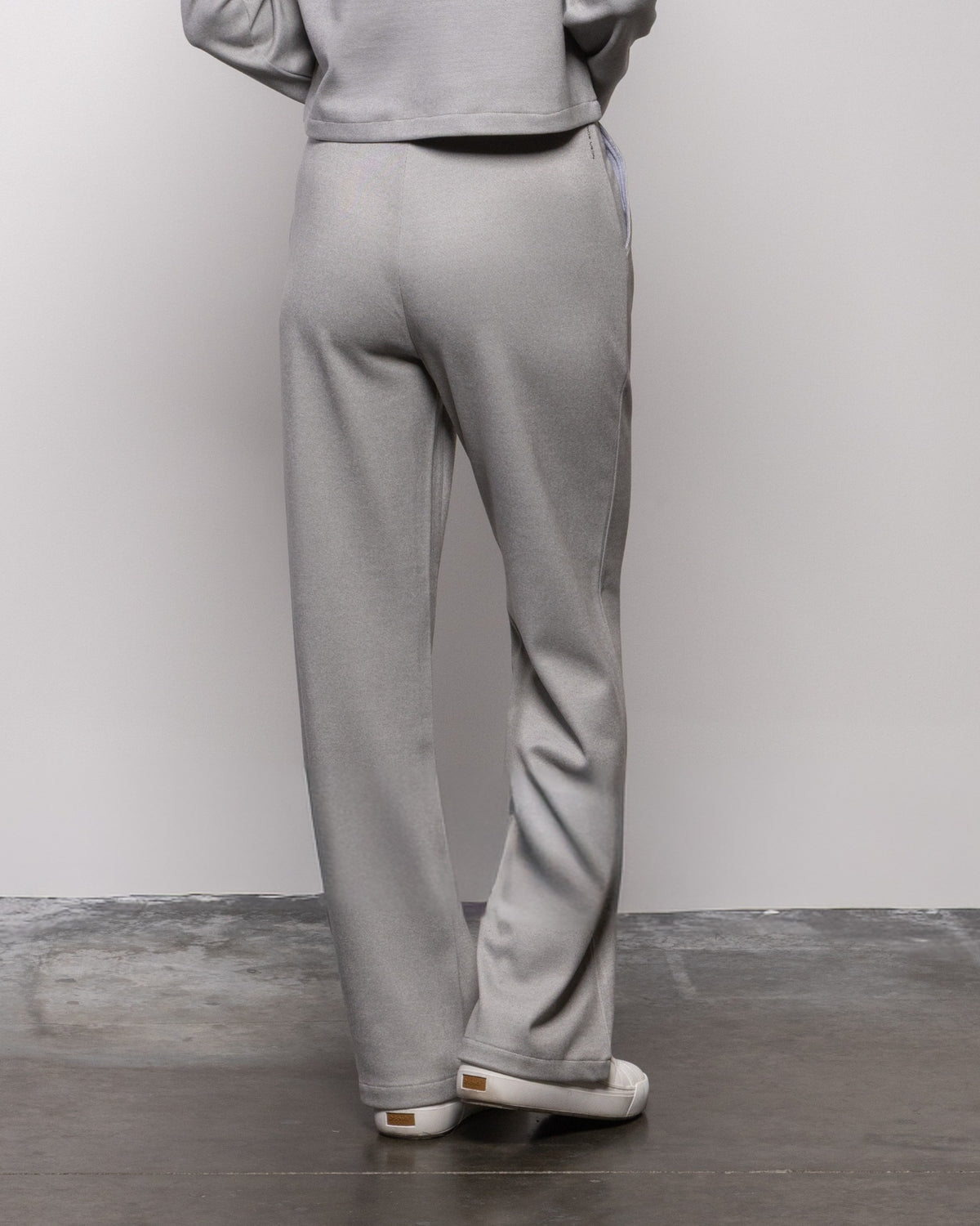 Light gray straight-leg pants with visible seam details and cuffed hem