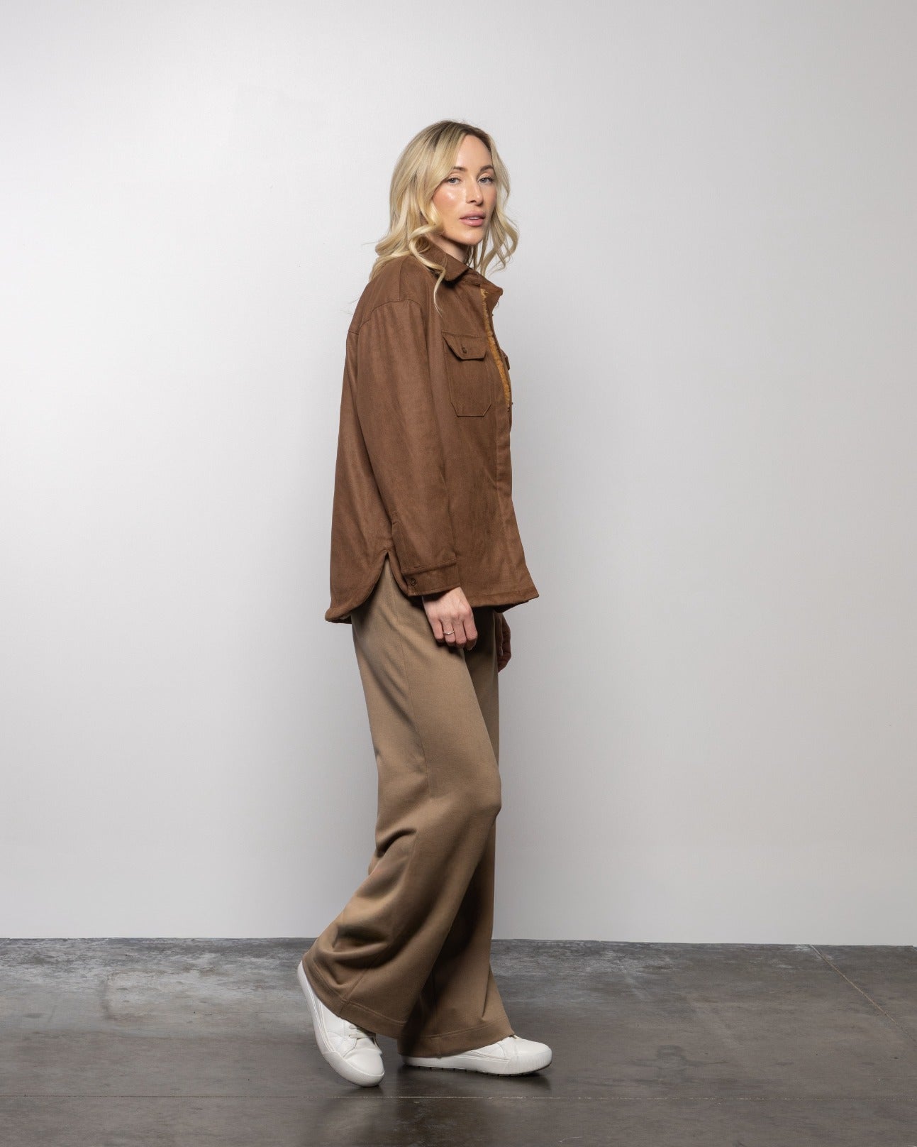 Brown shirt jacket with flap chest pocket and button front, side view