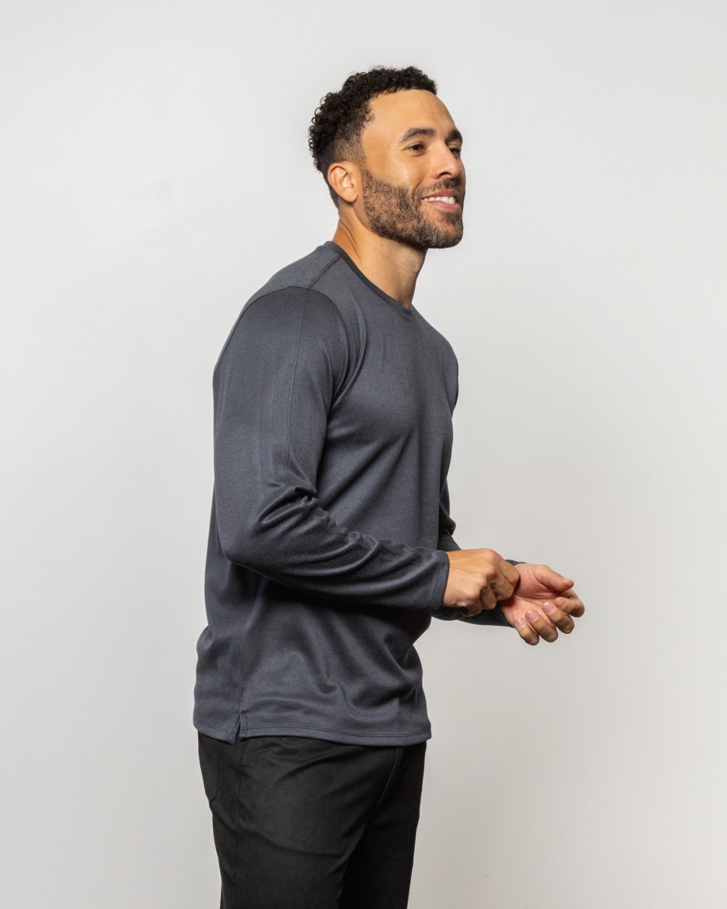 Tall crewneck sweatshirt, dark indigo-blue, side view with long sleeves and cuffs