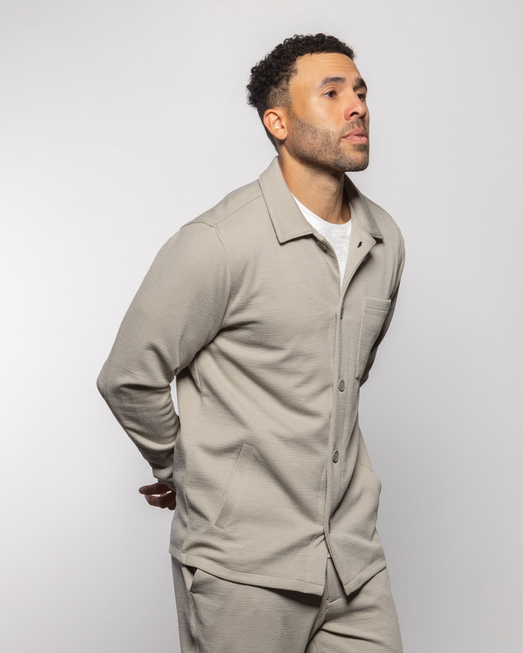 Light gray jacket with notched collar and button placket, side view