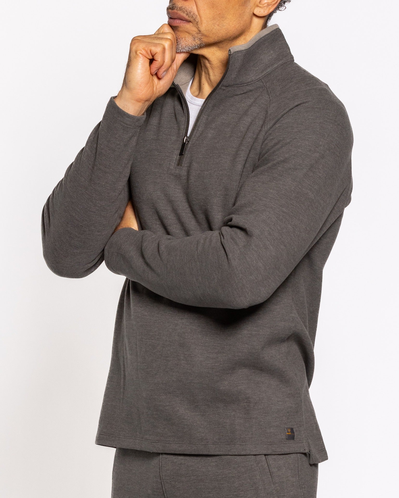 Men's gunmetal quarter-zip pullover close-up of stand collar and zipper