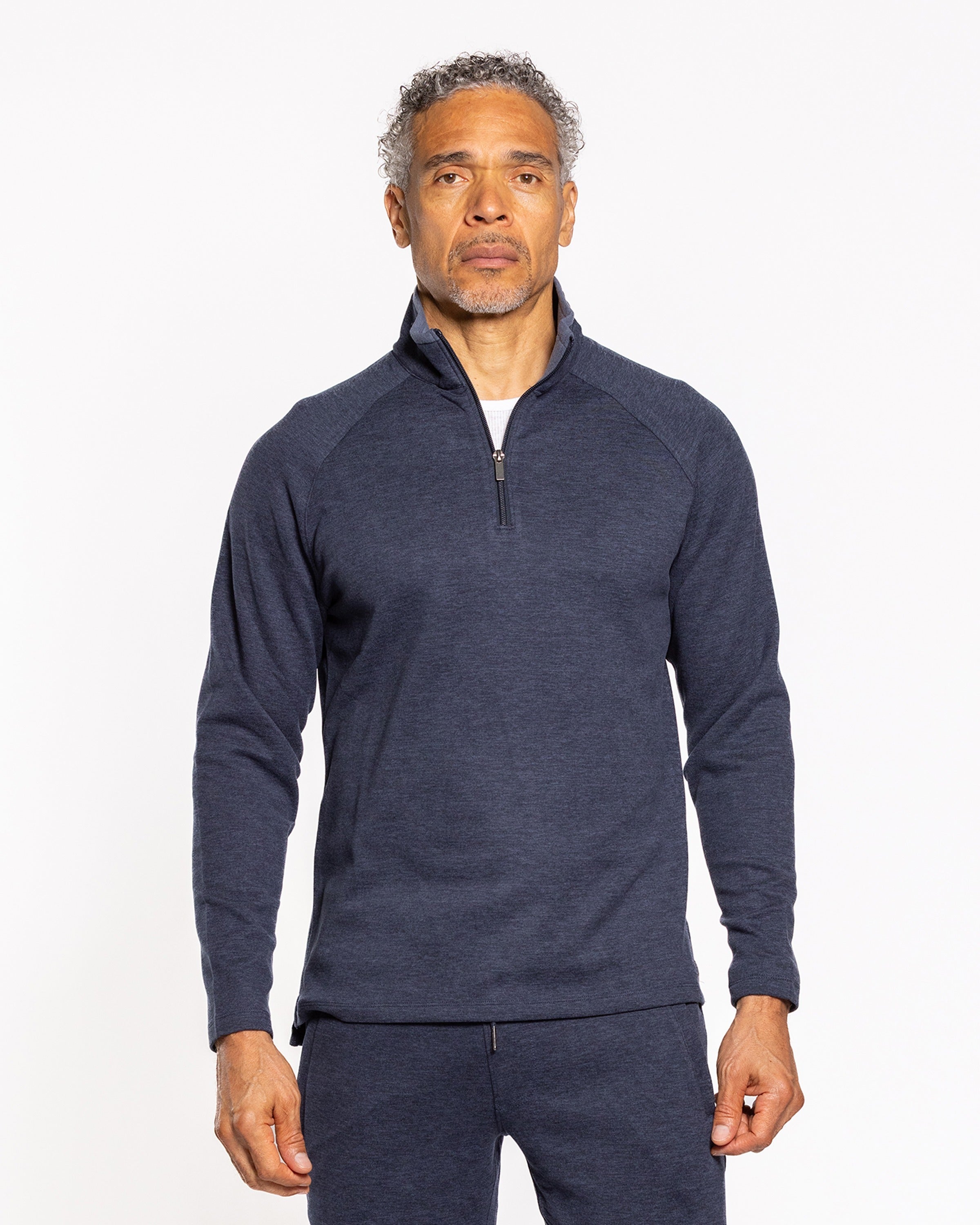 Men's dark indigo quarter-zip pullover, front view with stand collar and zip.