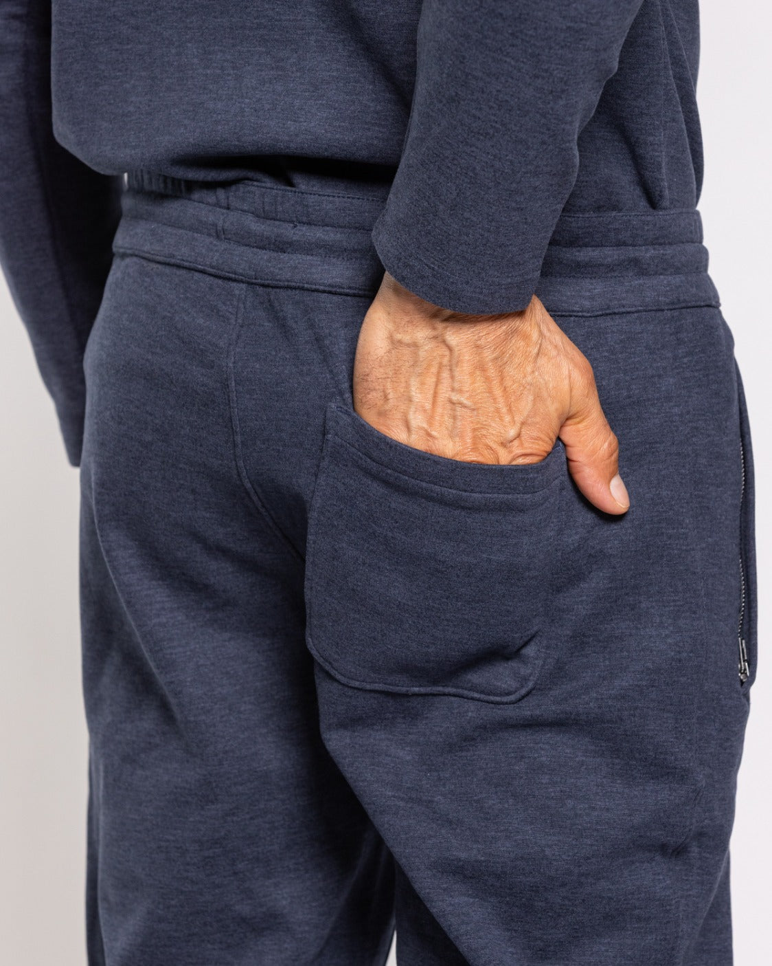 Navy jogger pants close-up with drawstring waist and side pocket detail
