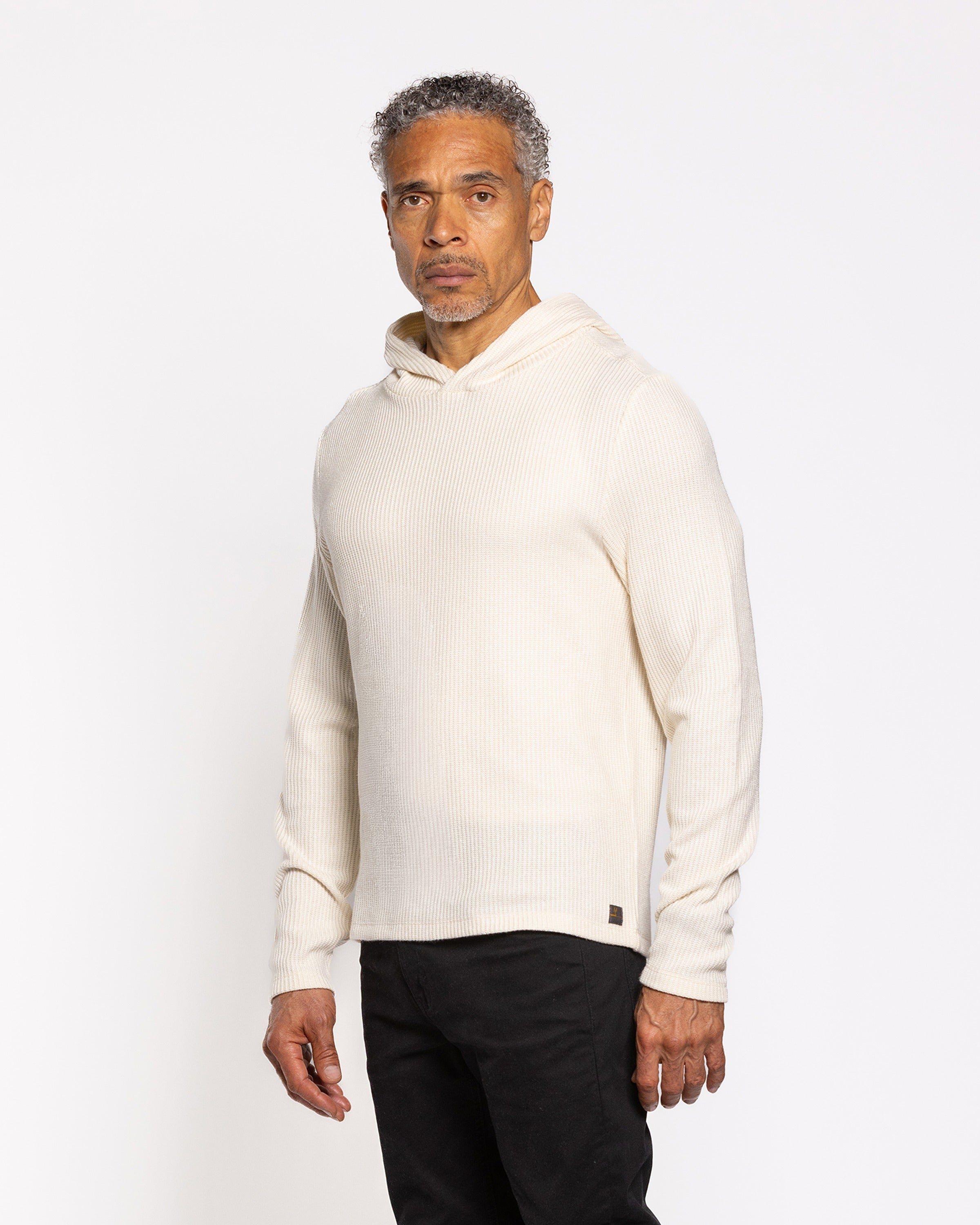 Cream ribbed pullover hoodie with adjustable hood and long sleeves