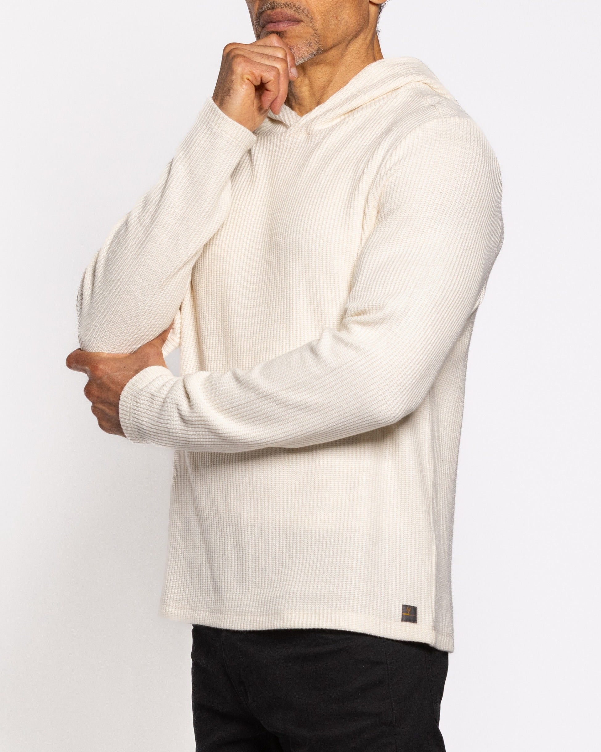 Off-white ribbed hoodie with hood, front seam detail, and long sleeve cuffs