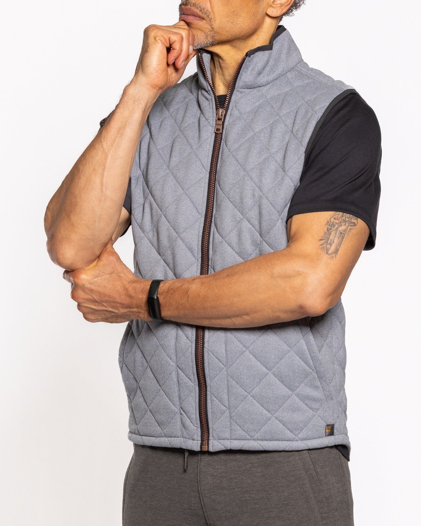 Quilted gray sleeveless vest with zip-front closure and diamond stitch pattern