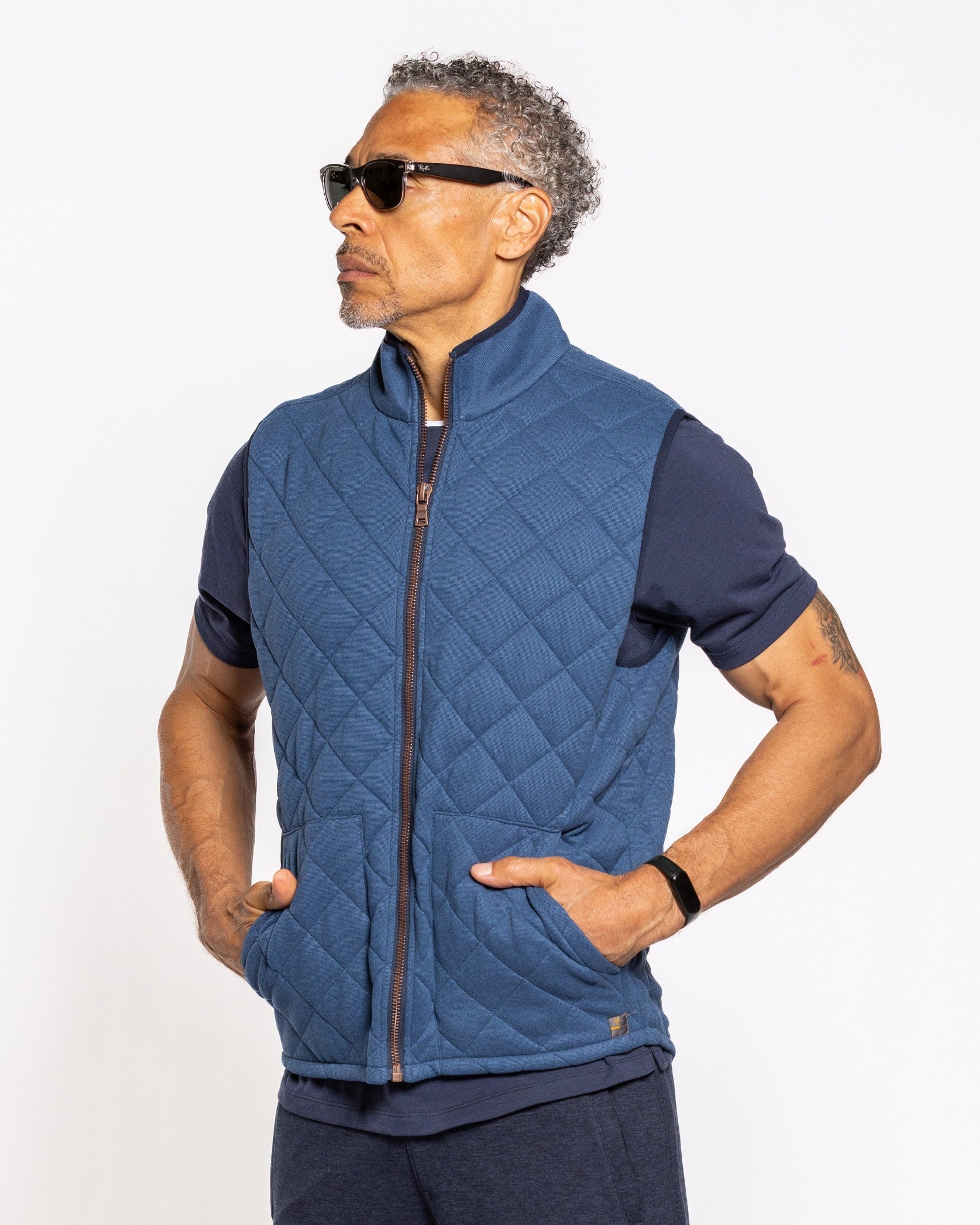 Quilted indigo vest with full-zip front, stand collar, and side pockets