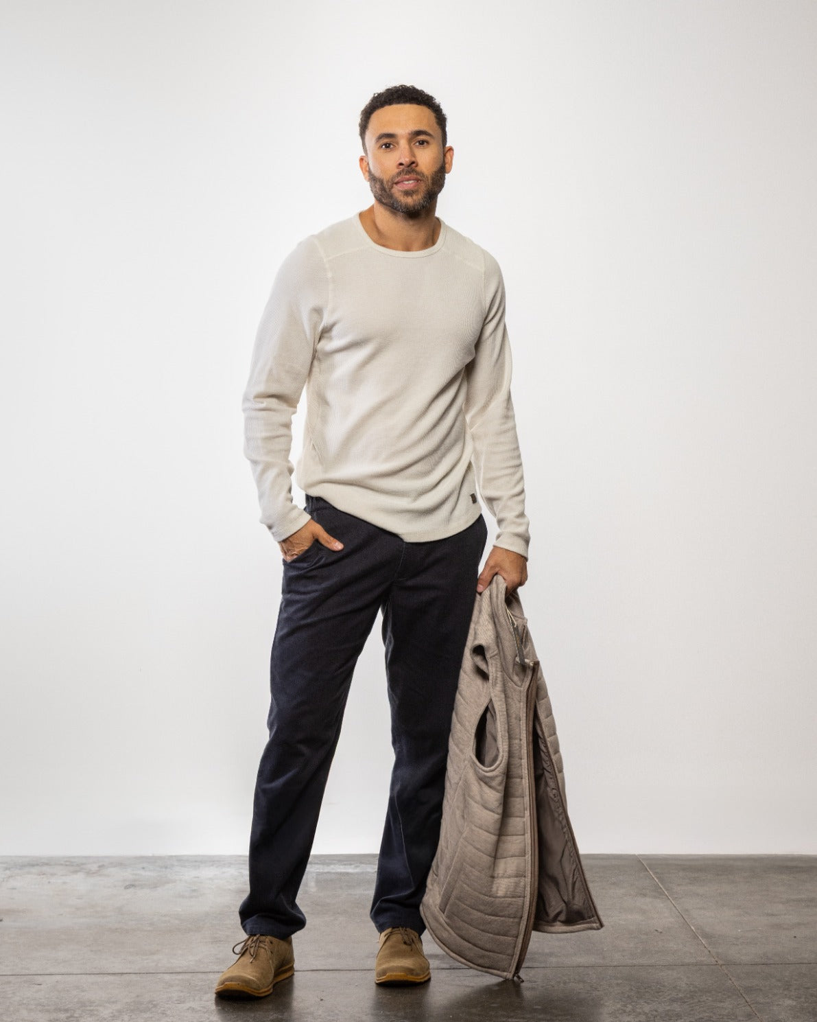 Light off-white crewneck long-sleeve knit shirt, full-length model view