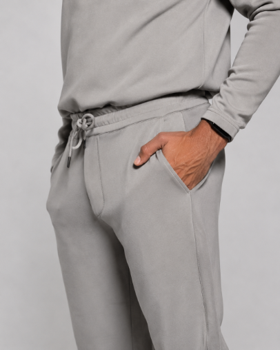 Gray jogger pants close-up: drawstring waist, hand pocket, ribbed hem